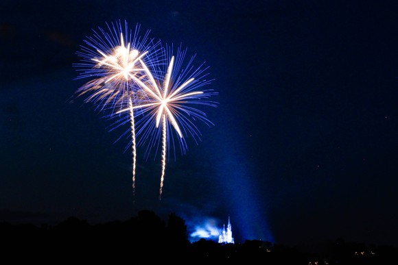 A Disney fireworks show, with a Disney castle in the background.