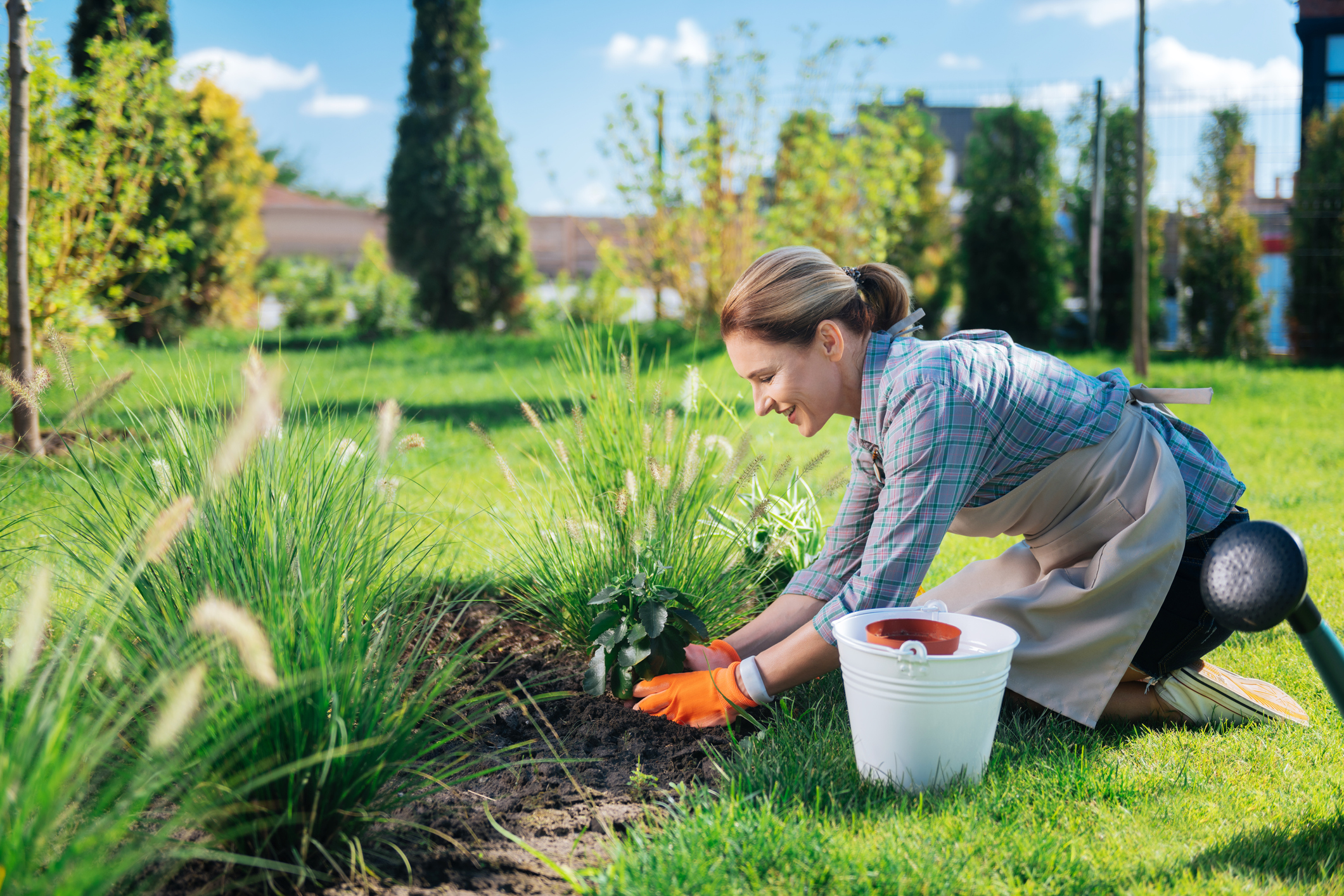 A woman planting something in a garden