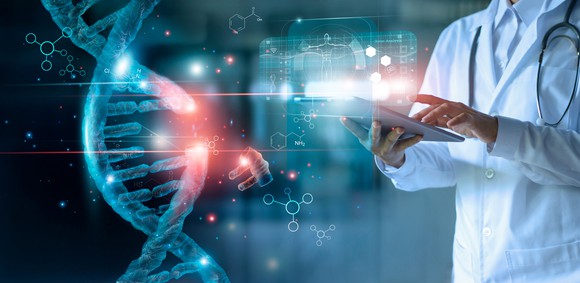 dna chain and scientist working on tablet