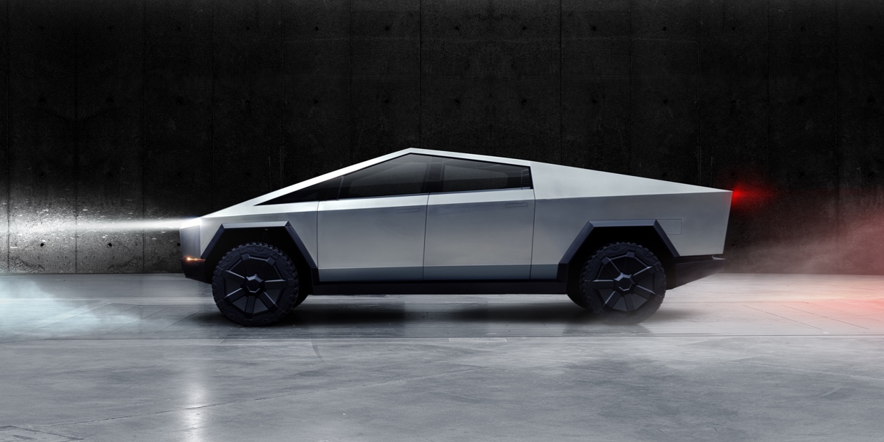 Tesla cybertruck against a black background.