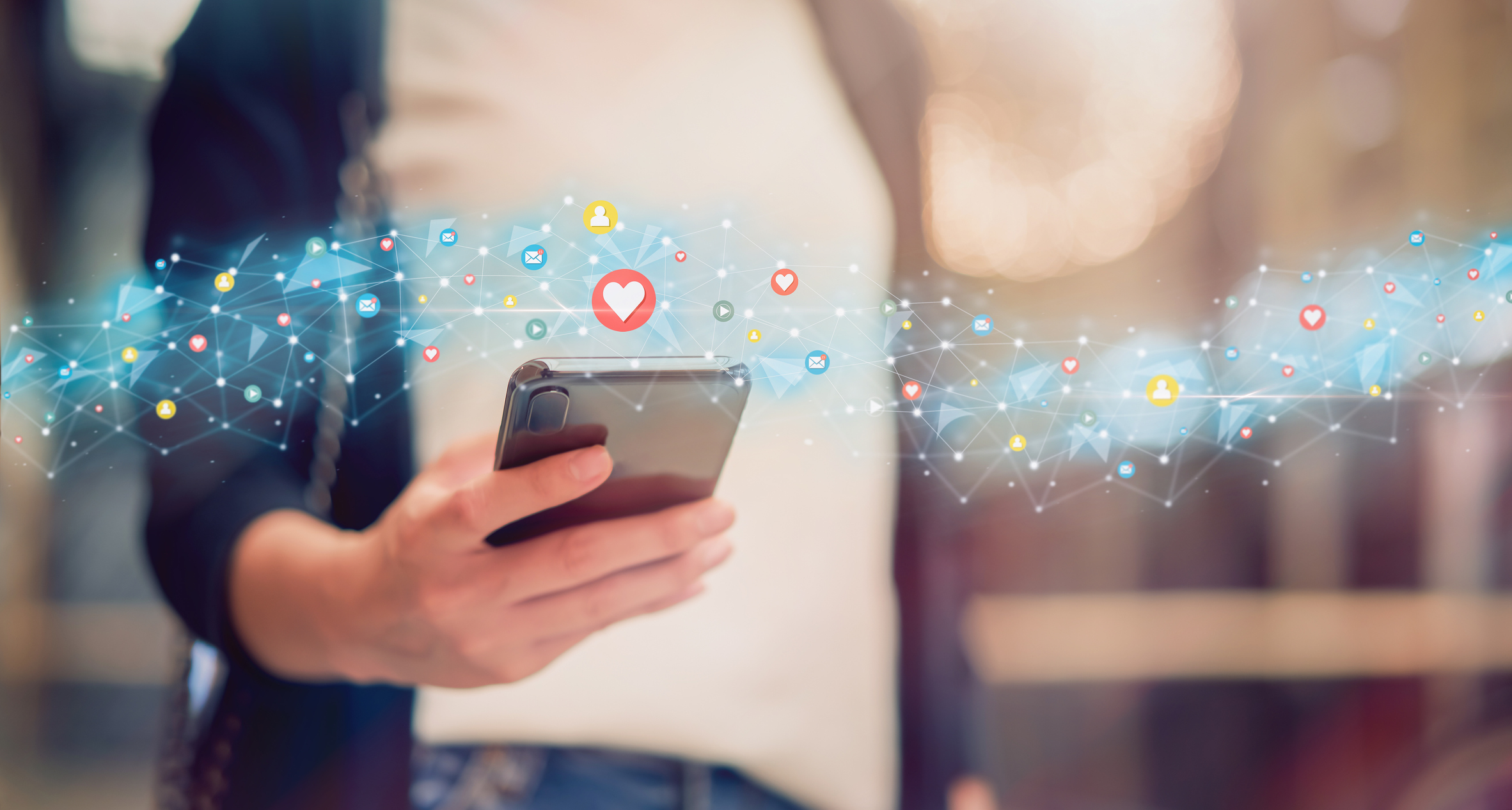 A woman uses a social media app on her smartphone.