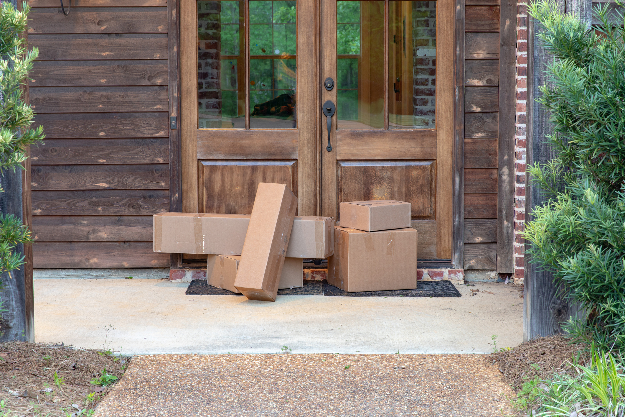Boxes sitting at someone's front door.