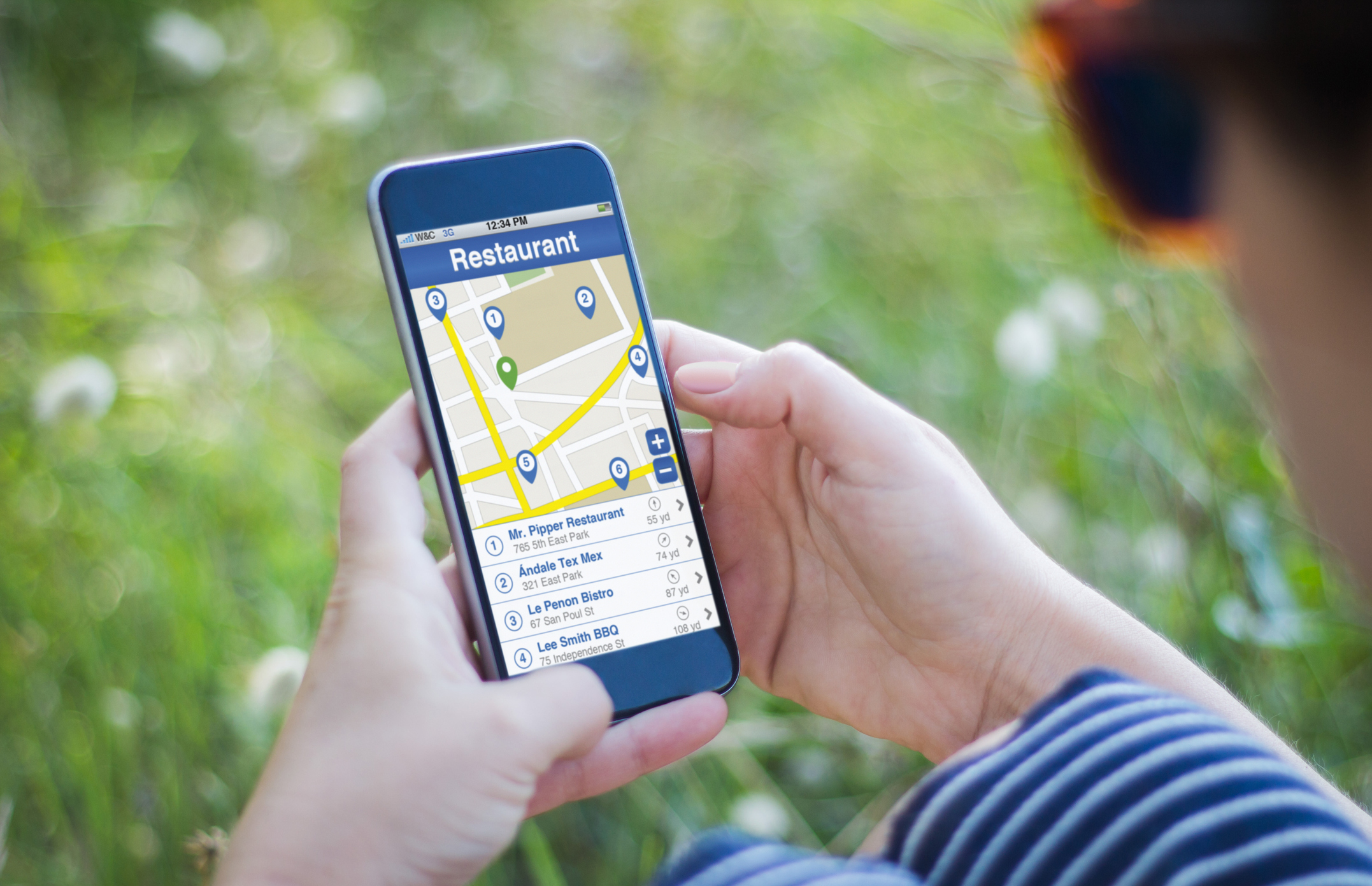 Closeup of a cell phone appearing to be open to  Google Maps looking for nearby restaurants.
