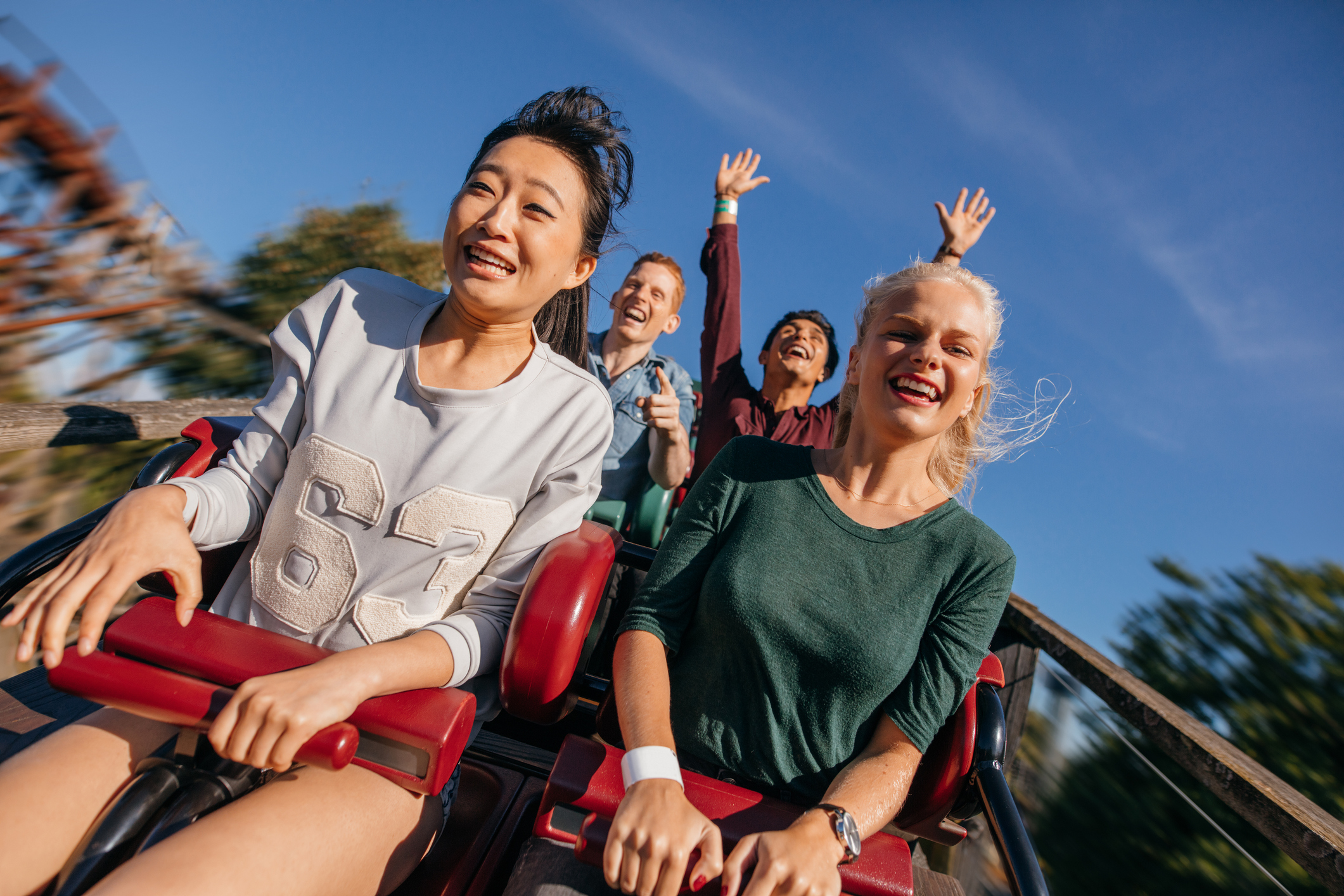 People riding a roller coaster.