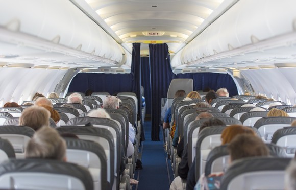 An airline cabin full of passengers
