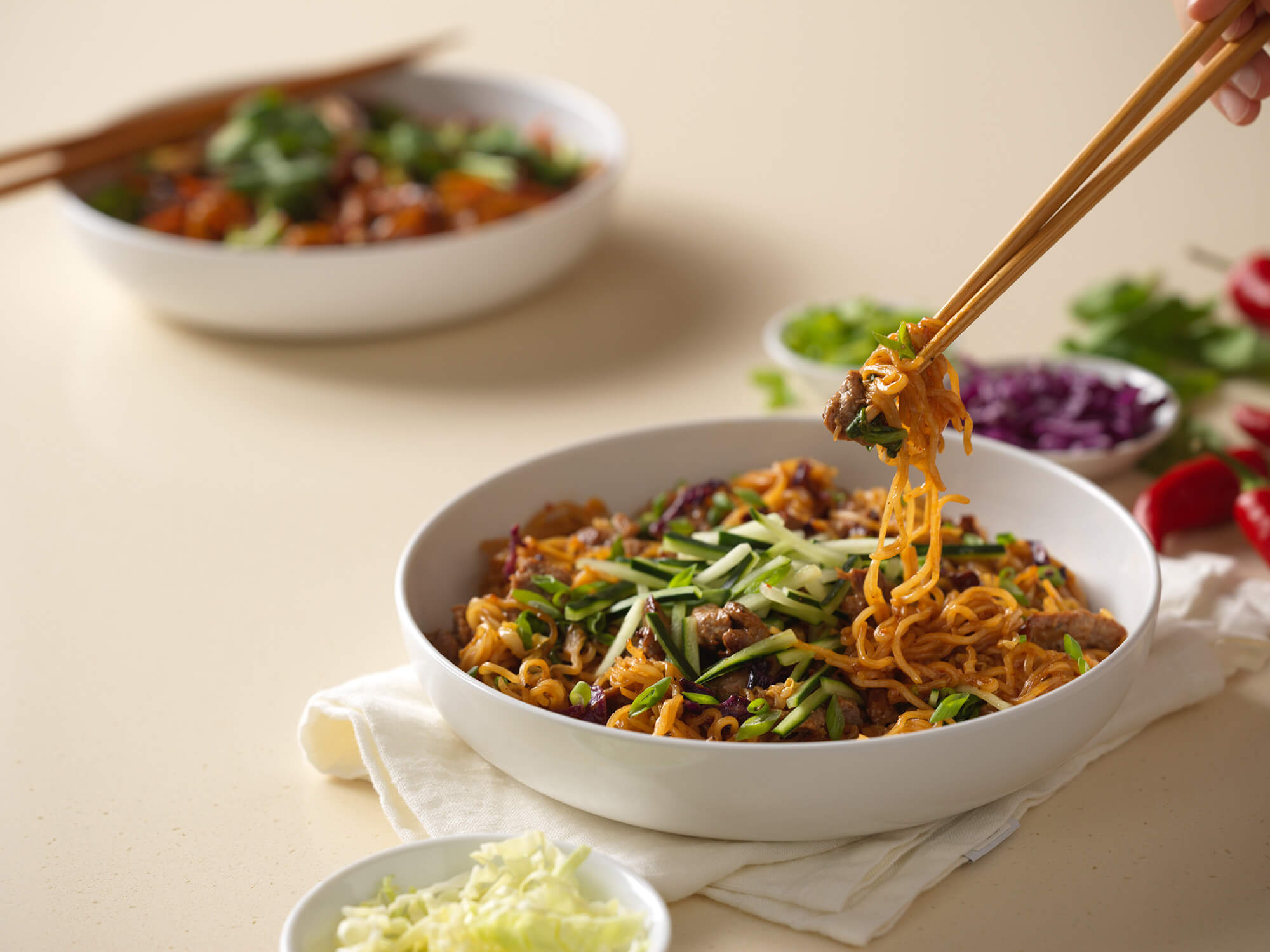Chopsticks hold spicy Korean beef noodles from Noodles & Company.