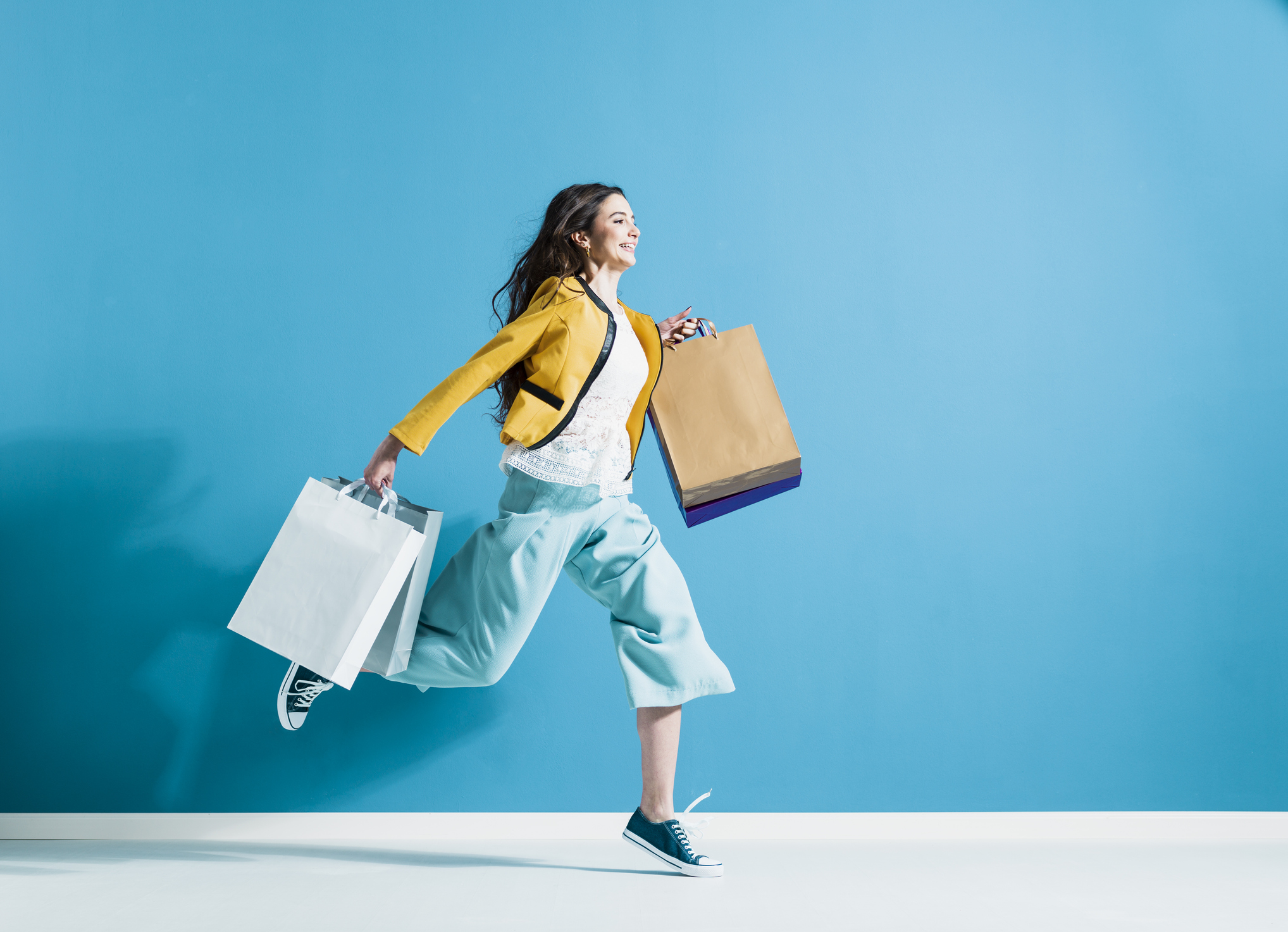 Woman running with shopping bags.