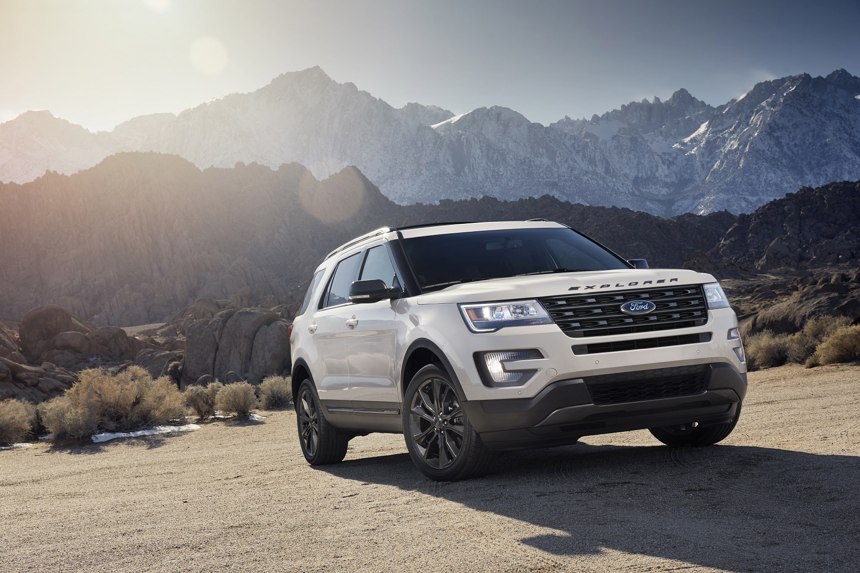A Ford Explorer with mountains in the distance.