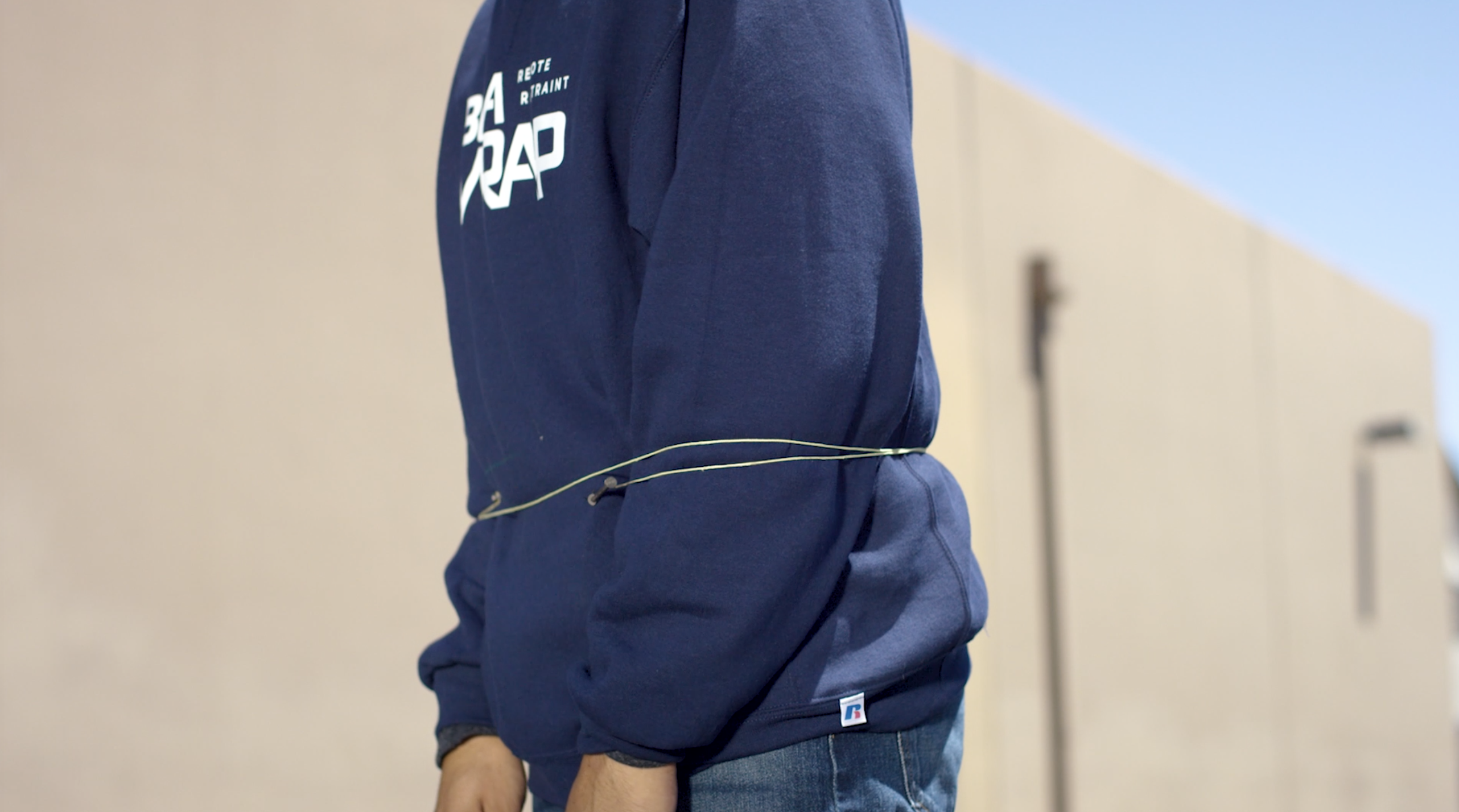 Person demonstrating being wrapped by BolaWrap