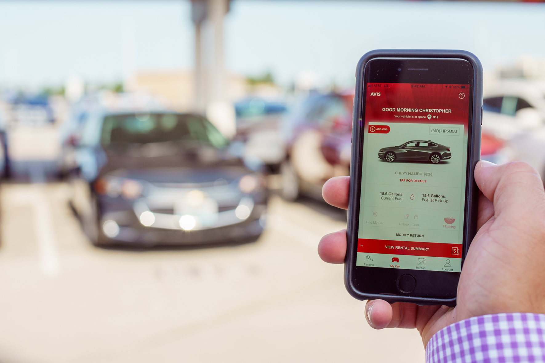 Customer securing Avis car rental with a smartphone.
