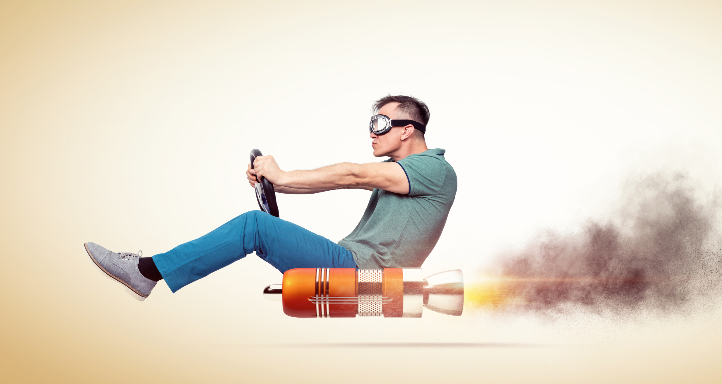 A man rides a rocket while holding a steering wheel.