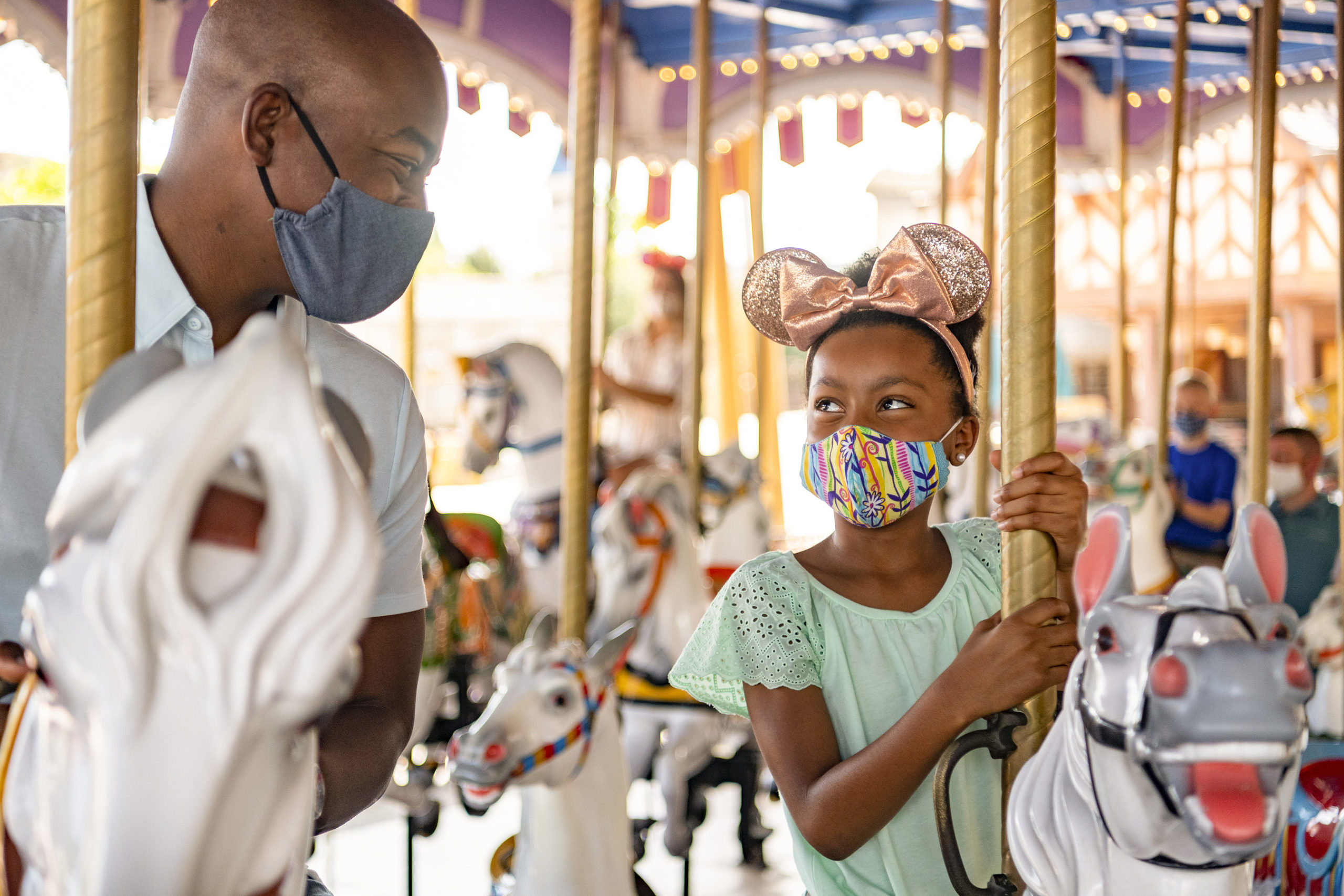 Girl and man enjoying a ride at Disney World.