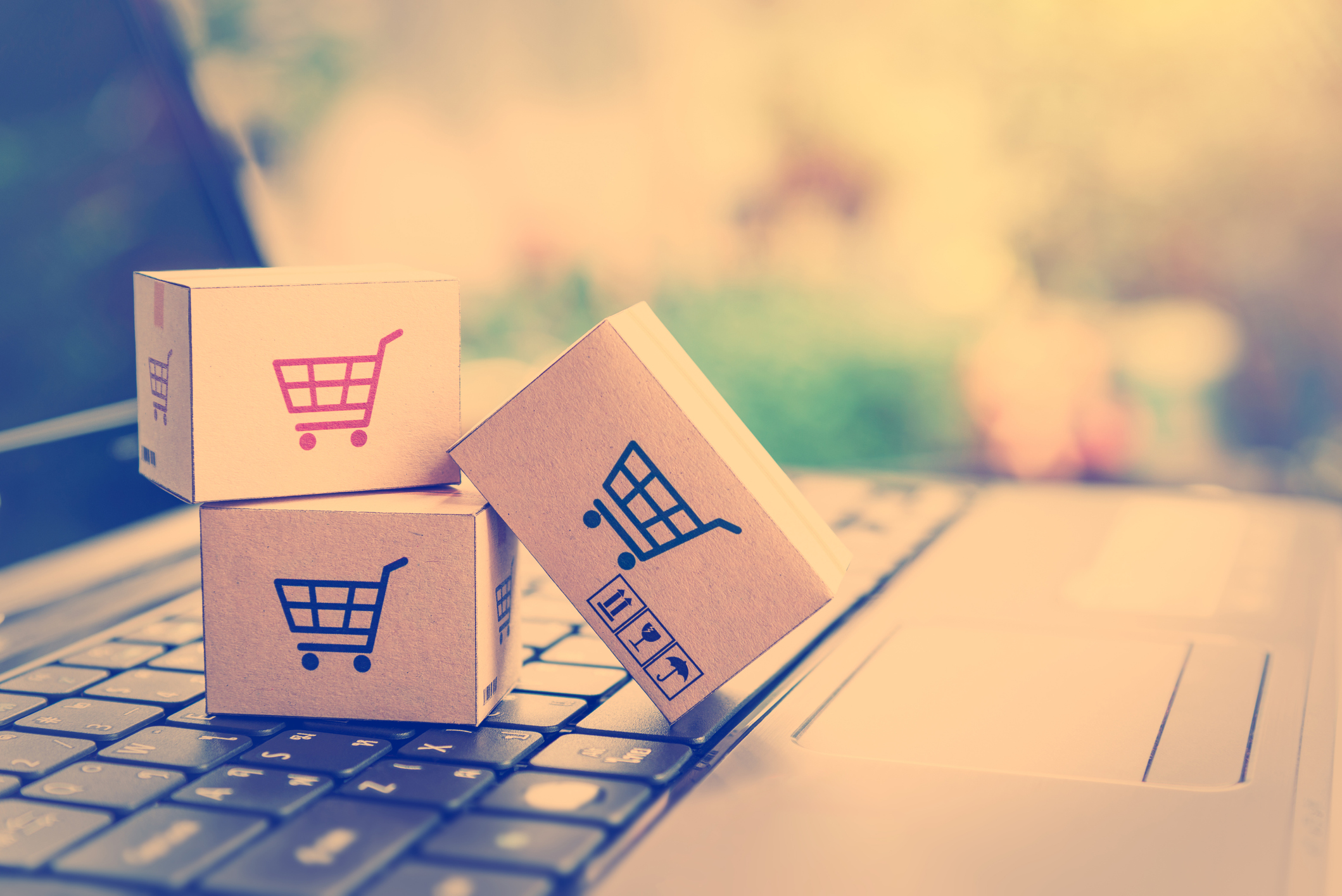 Tiny e-commerce packages on a keyboard.