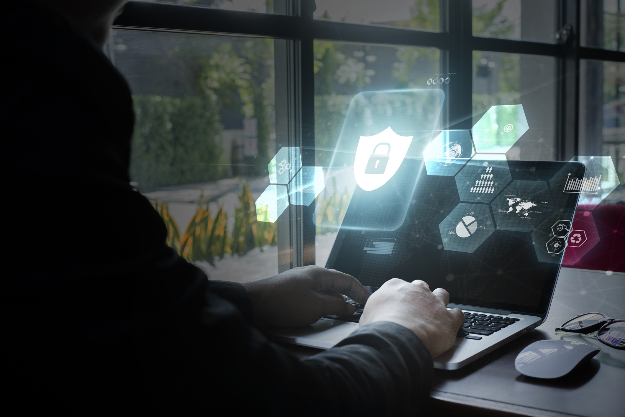 A person using a laptop and a lock icon.