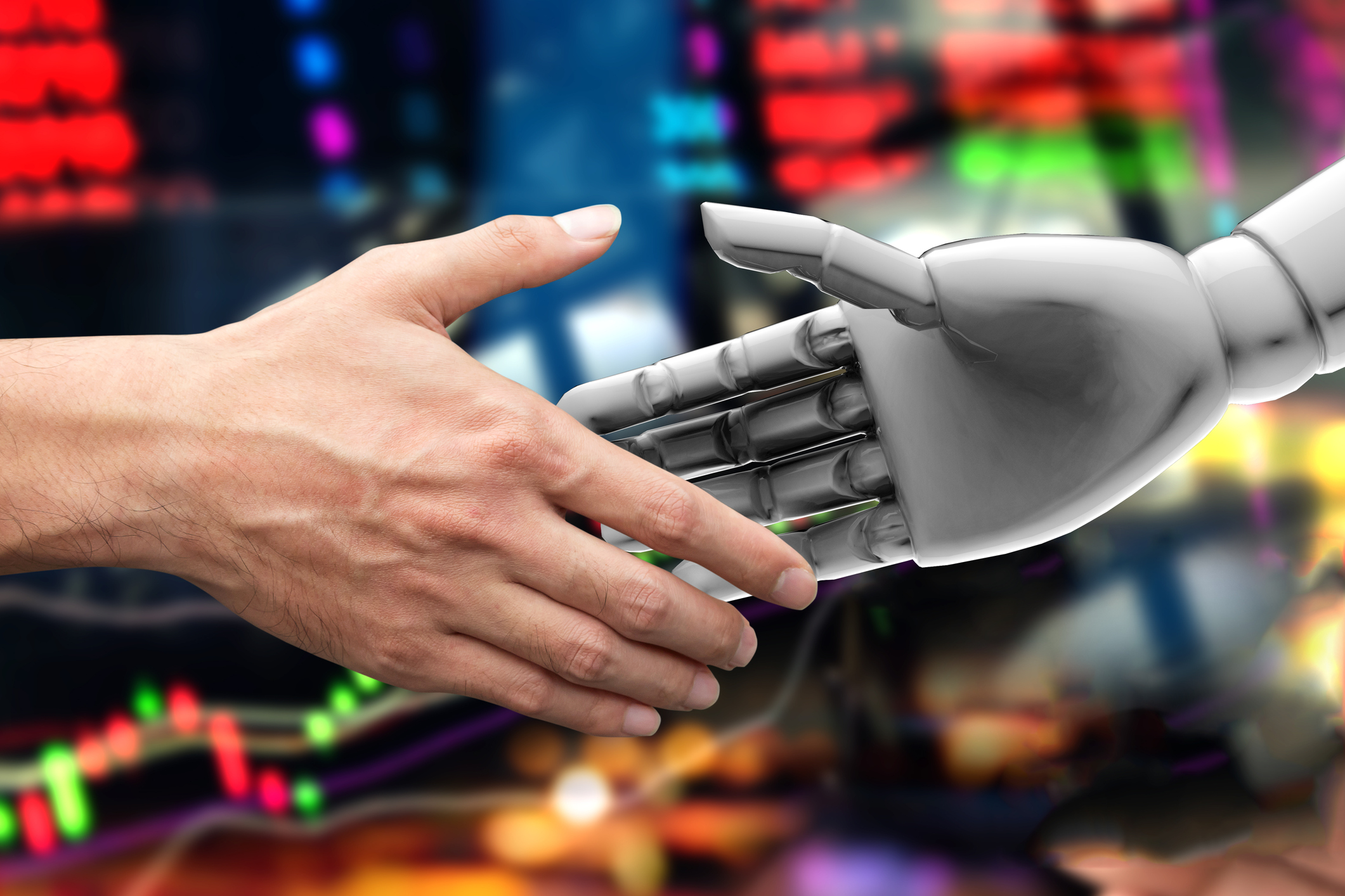 robot hand and human hands shaking