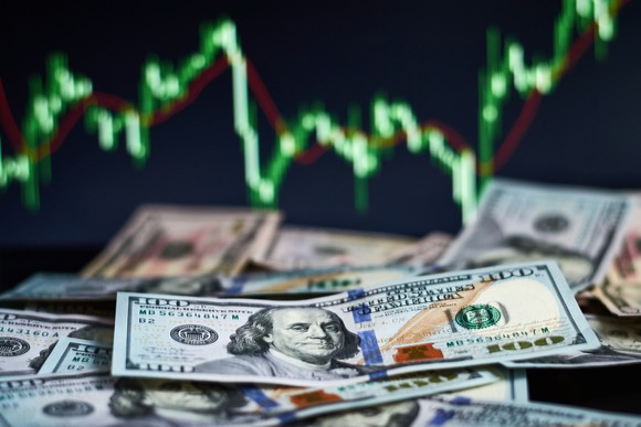 Money and a stock price chart.