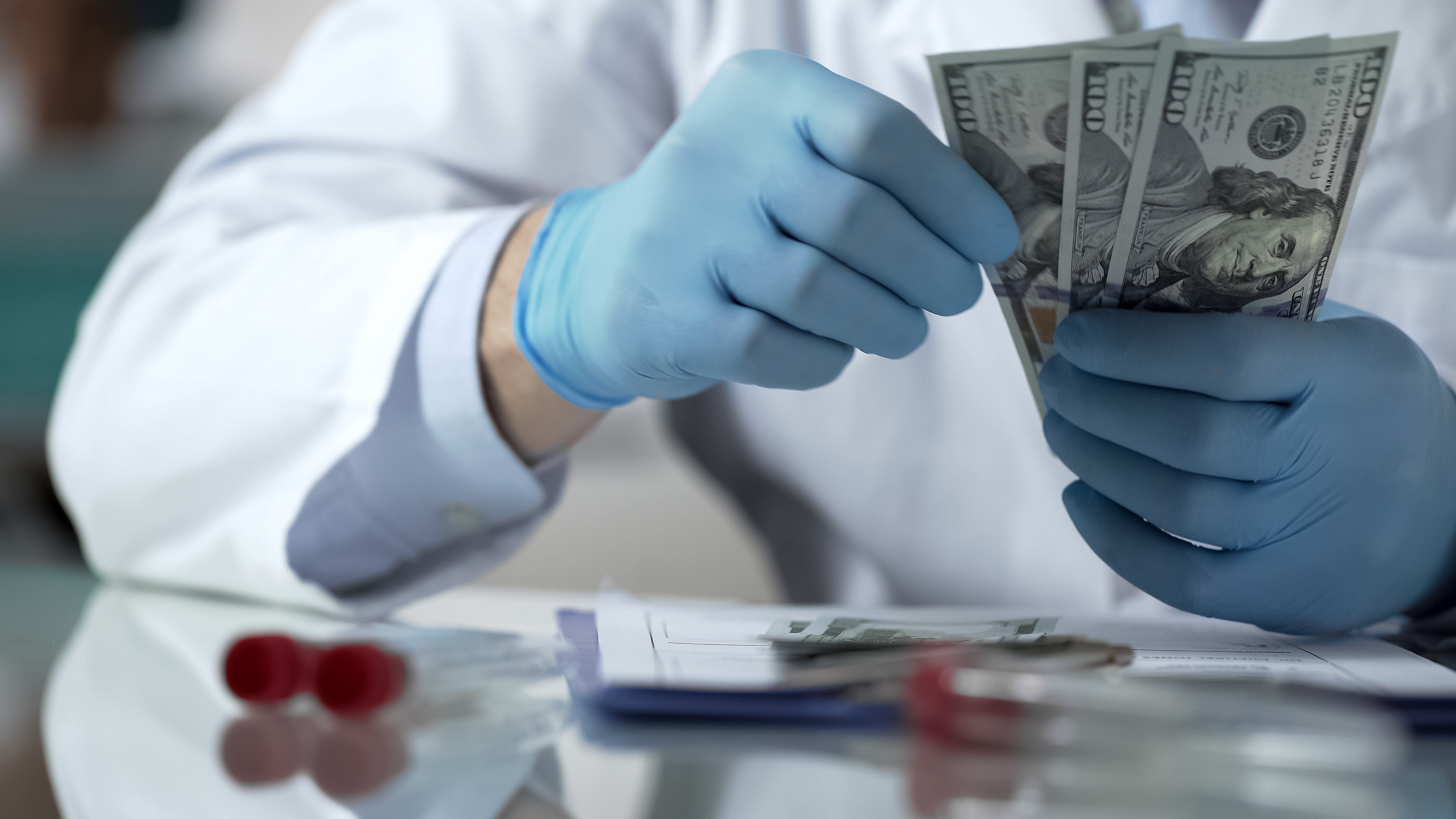 Scientist with $100 bills