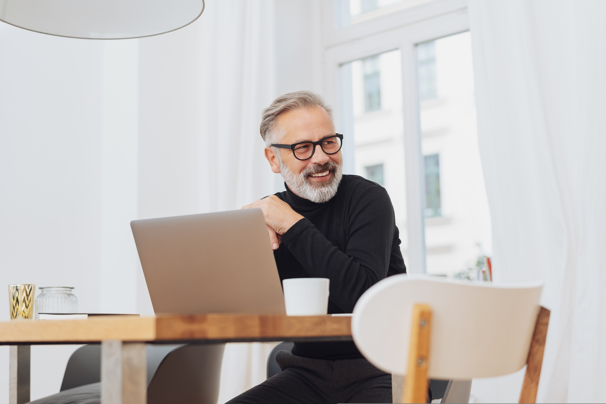 Smiling older man at laptop
