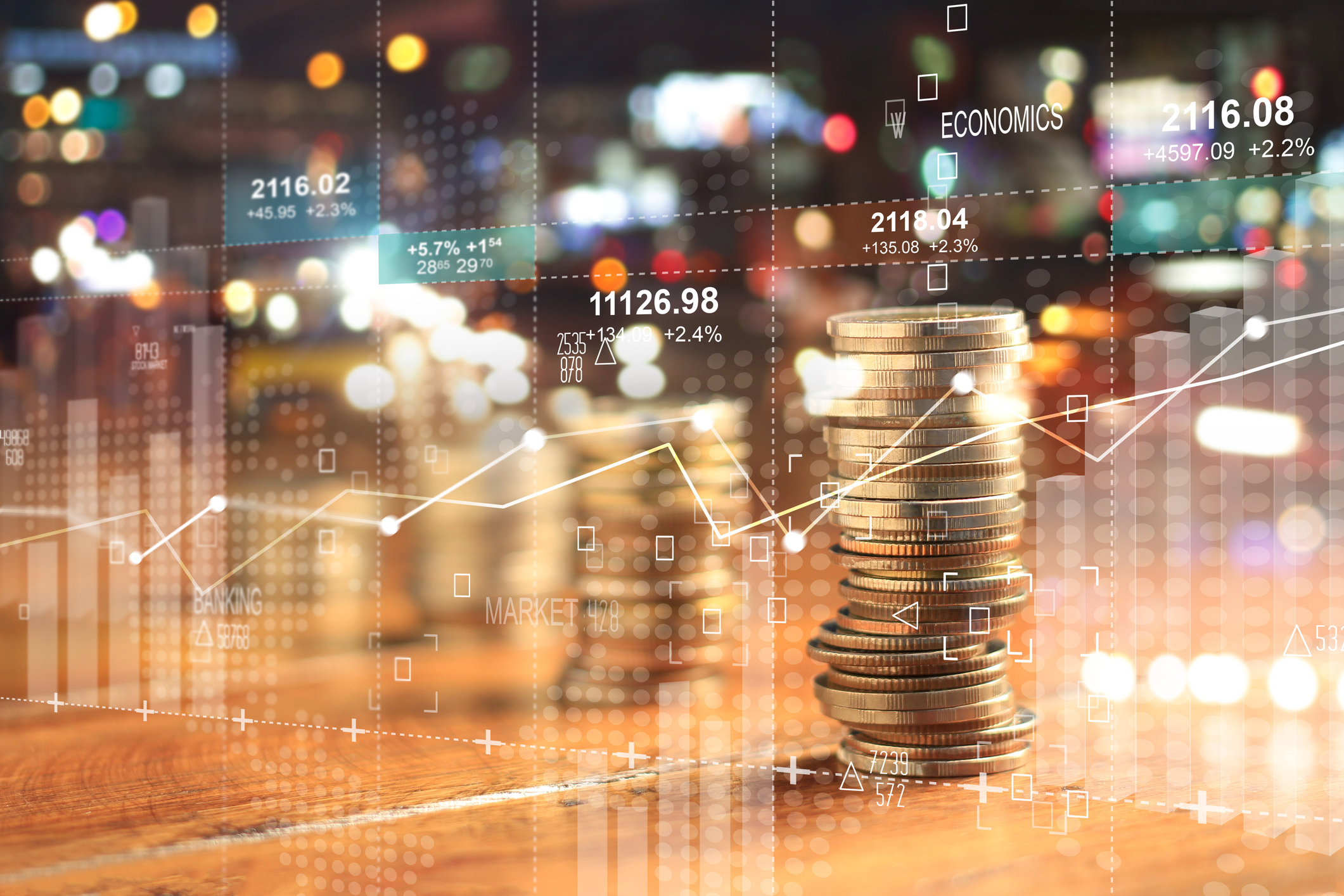 Stacks of coins and a stock chart.
