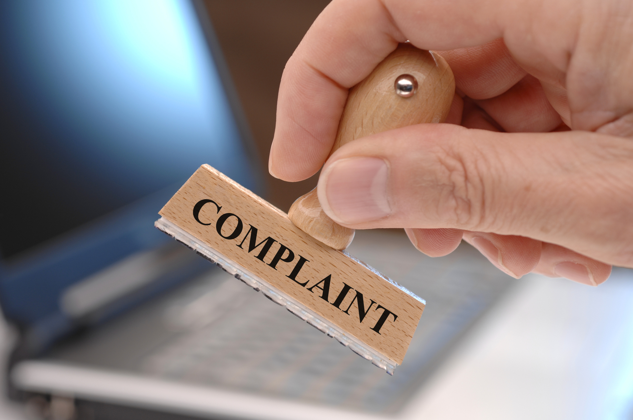 Wooden ink stamp that says "COMPLAINT"