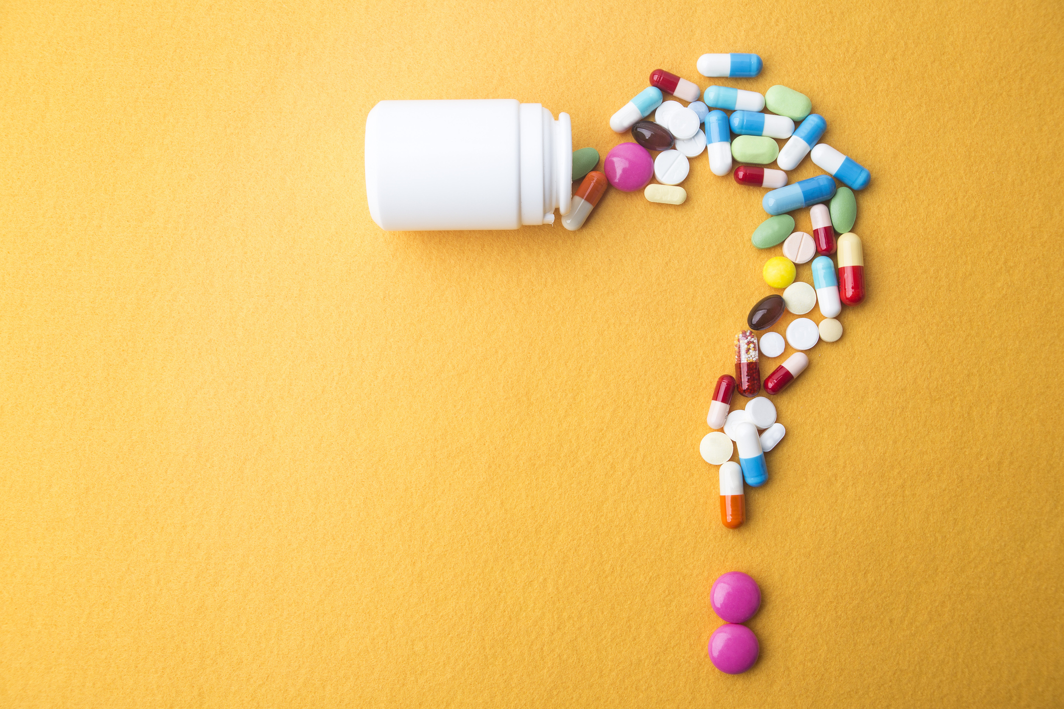 Medical drugs forming a question mark.