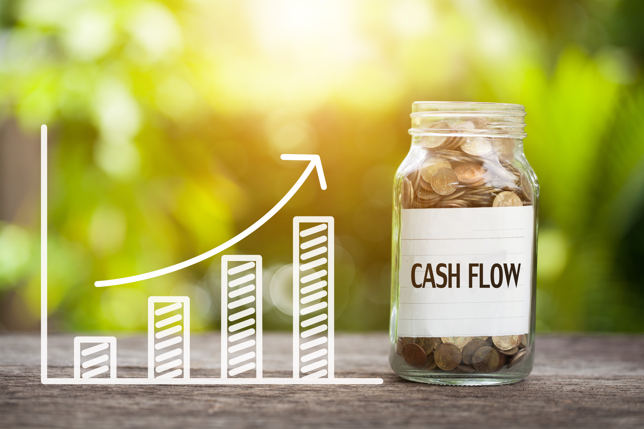 An illustrated rising bar graph leading to a transparent jar filled with coins and labeled "cash flow."