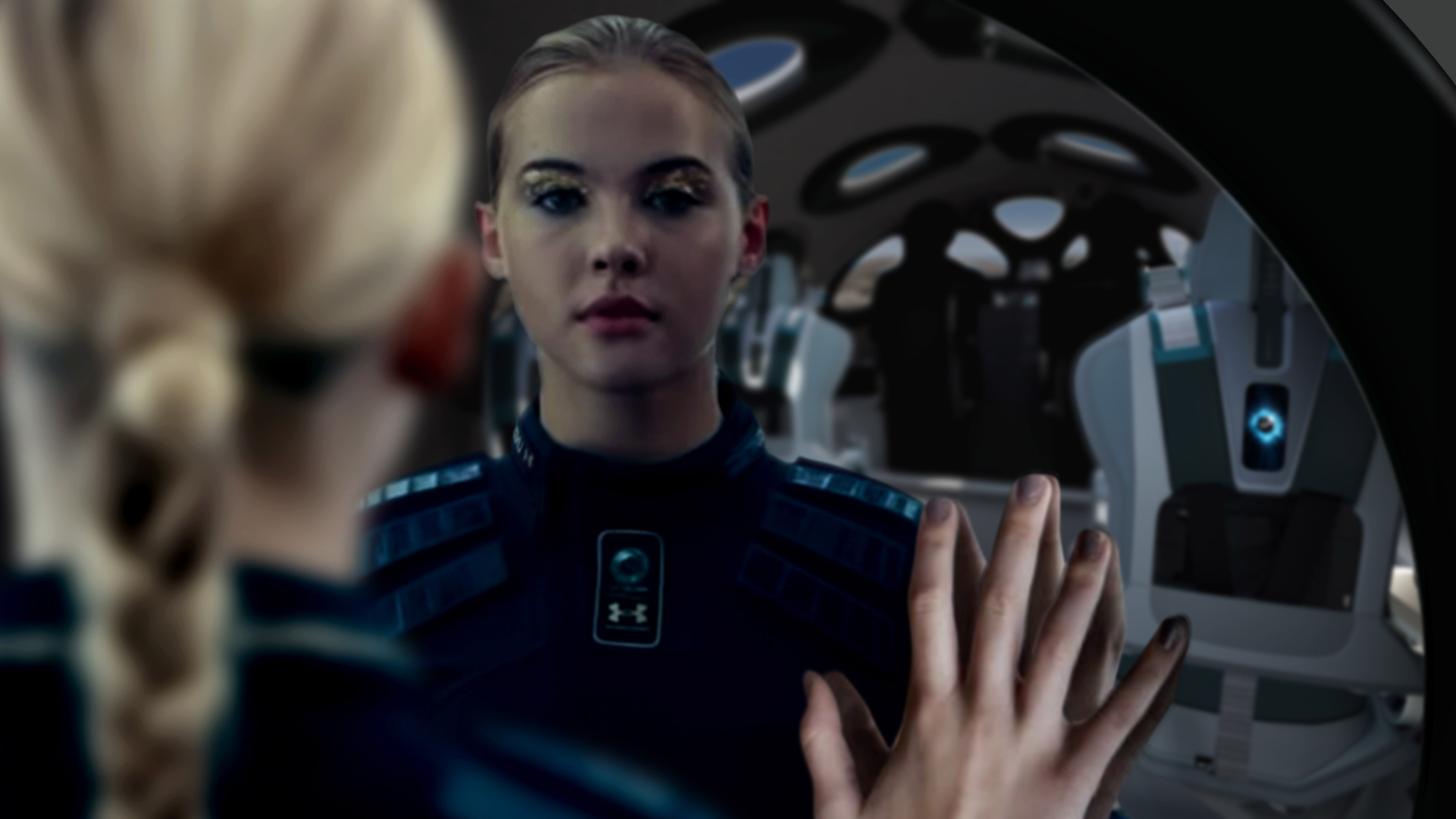 A woman's image is reflected in a mirror inside a Virgin Galactic spaceship.