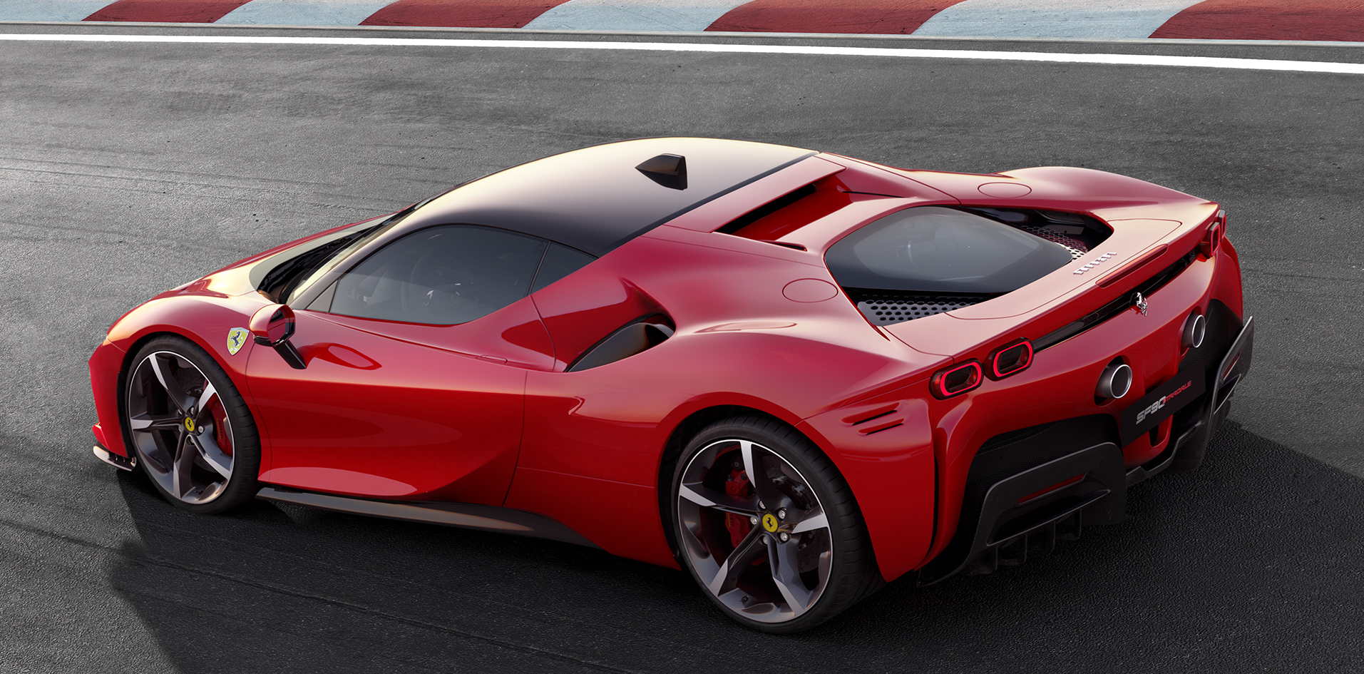 A red Ferrari SF90 Stradale, a two-seat exotic sports car, on a racetrack