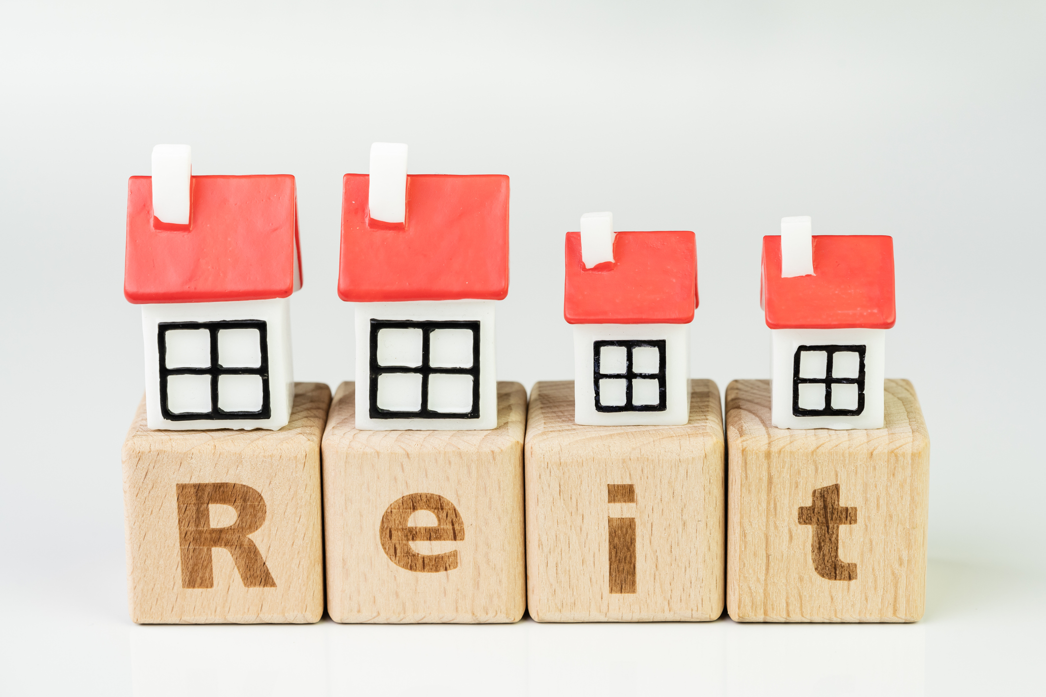 REIT spelled out in wooden blocks.