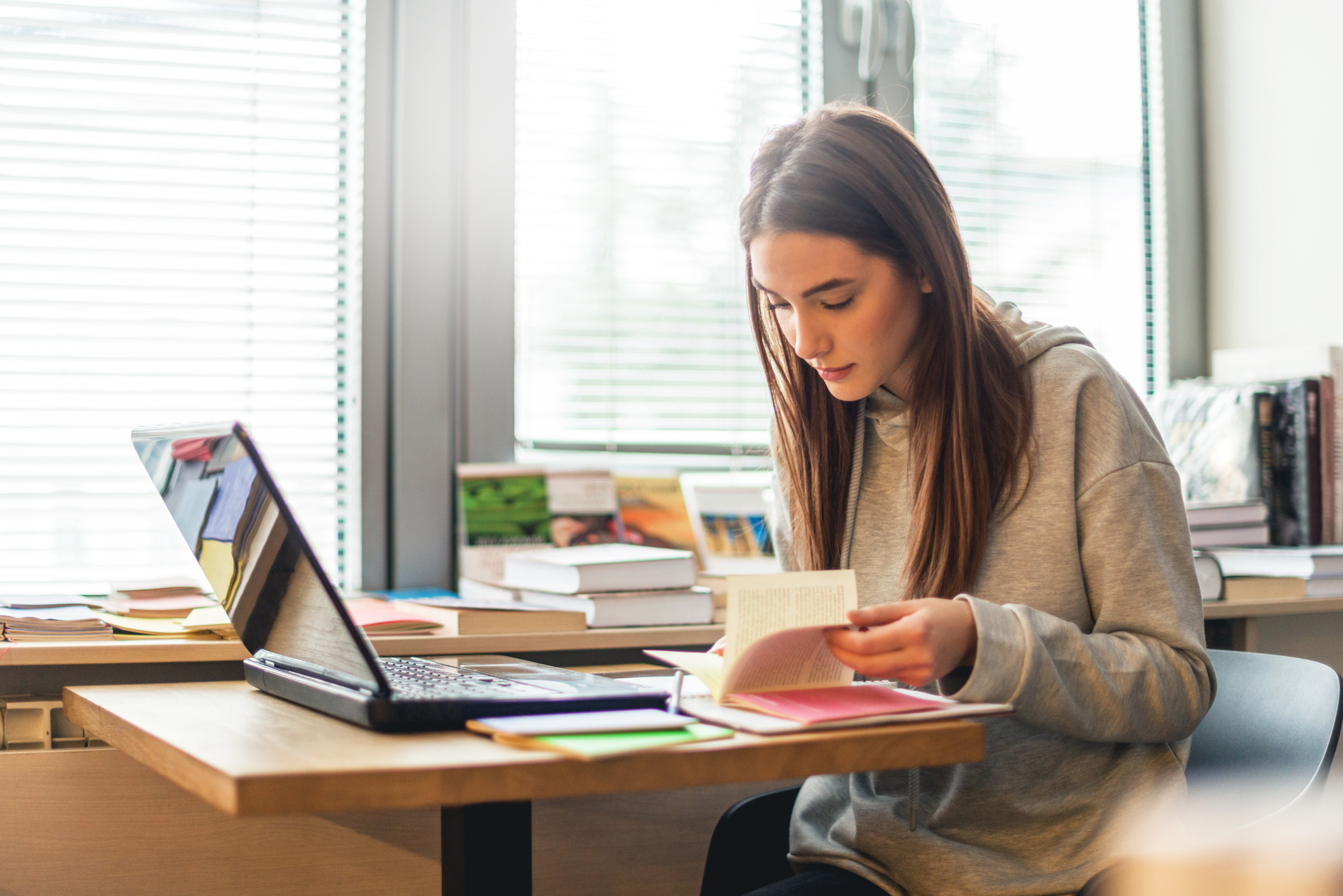A woman sitting at a laptop studying