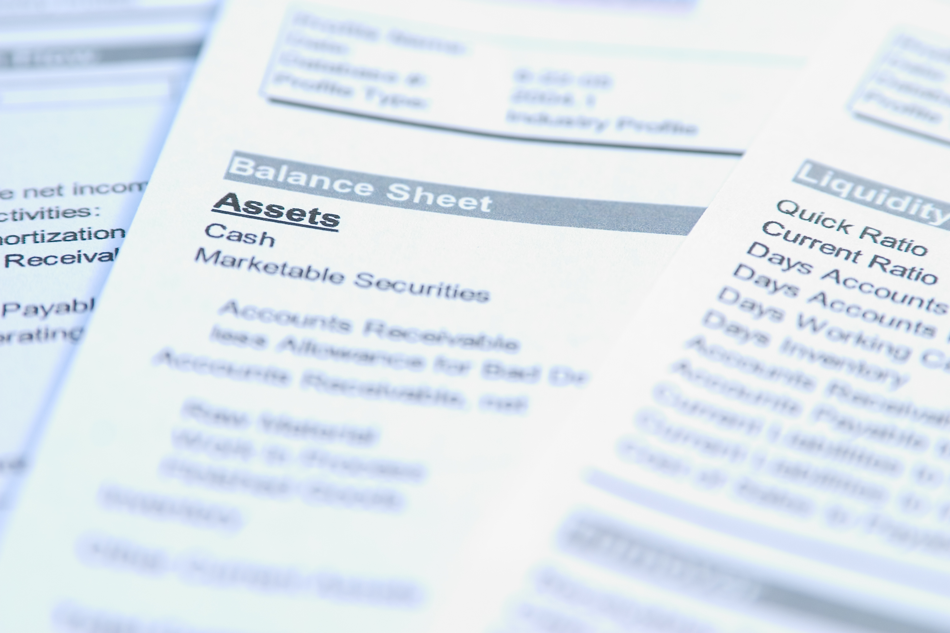 Financial papers showing balance sheet and liquidity figures