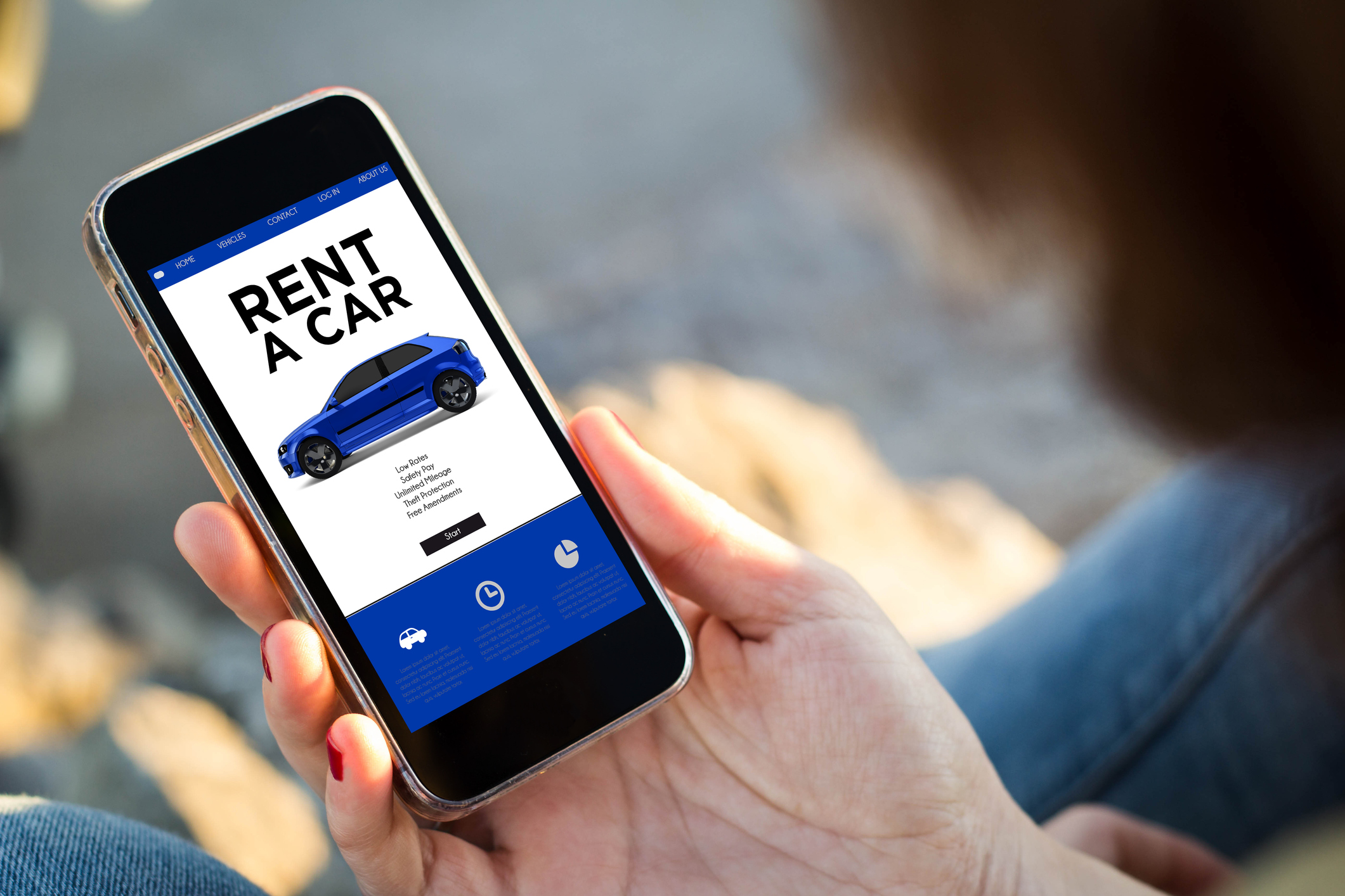 A woman looking at a car rental app on a smartphone.