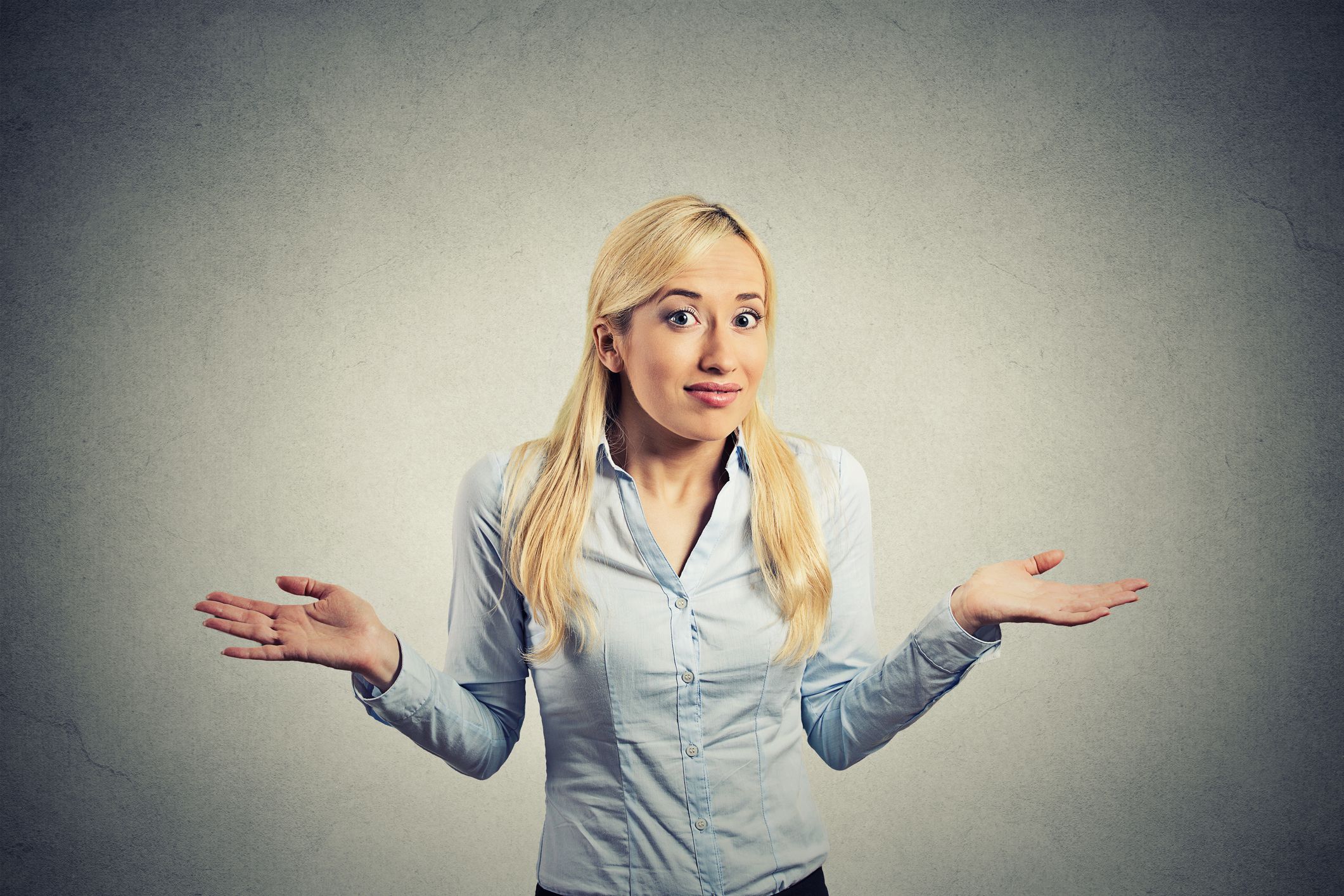 Confused woman shrugging