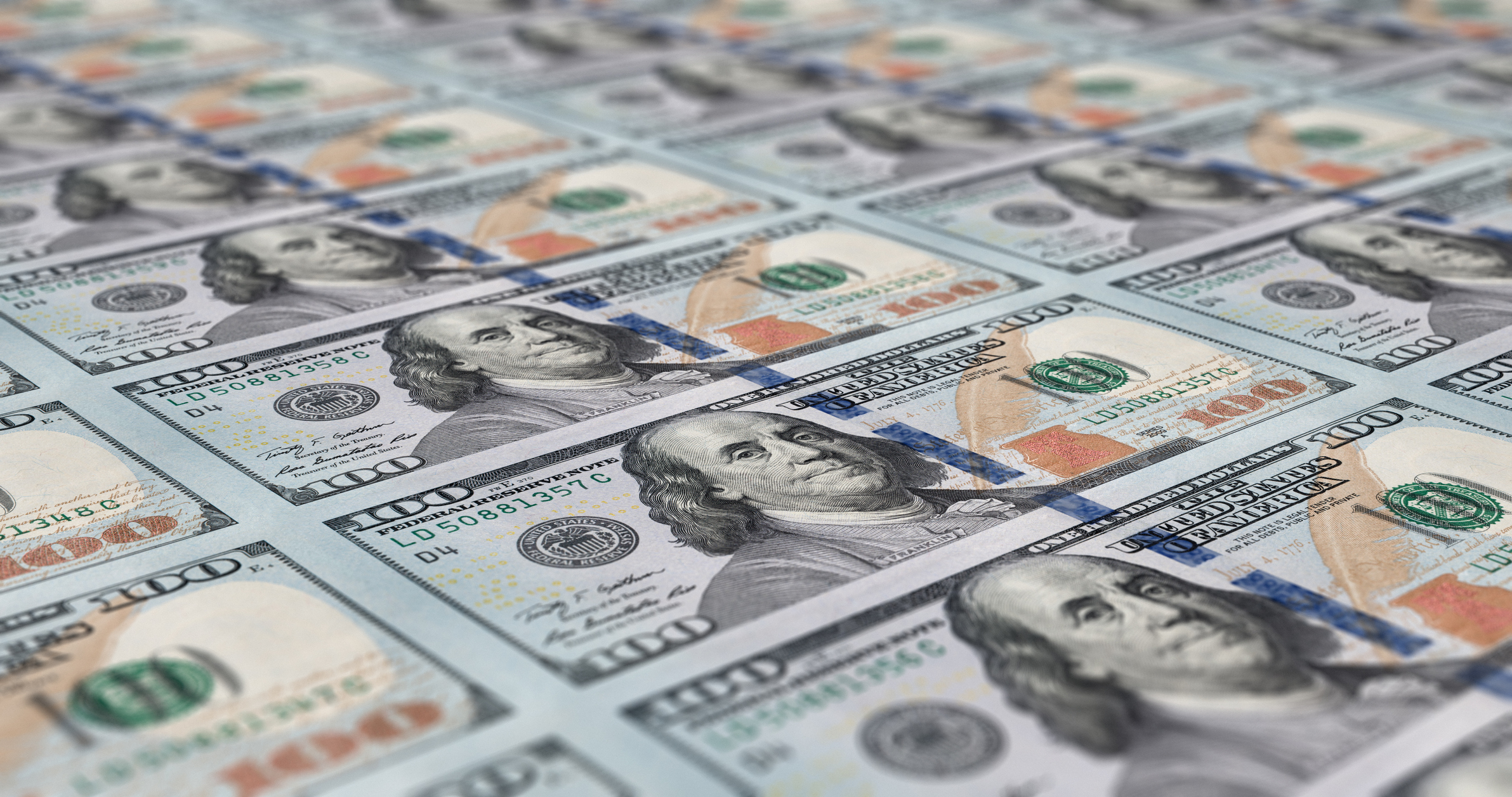 A sheet of $100 bills fresh of the printing press.