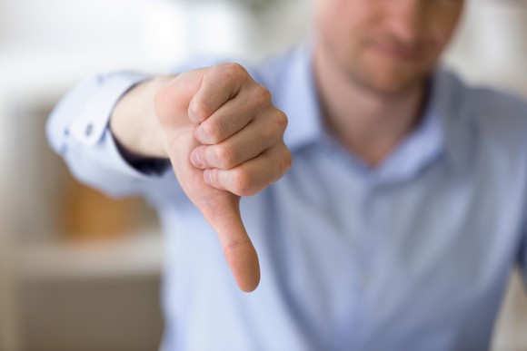 Man with thumb pointing down.