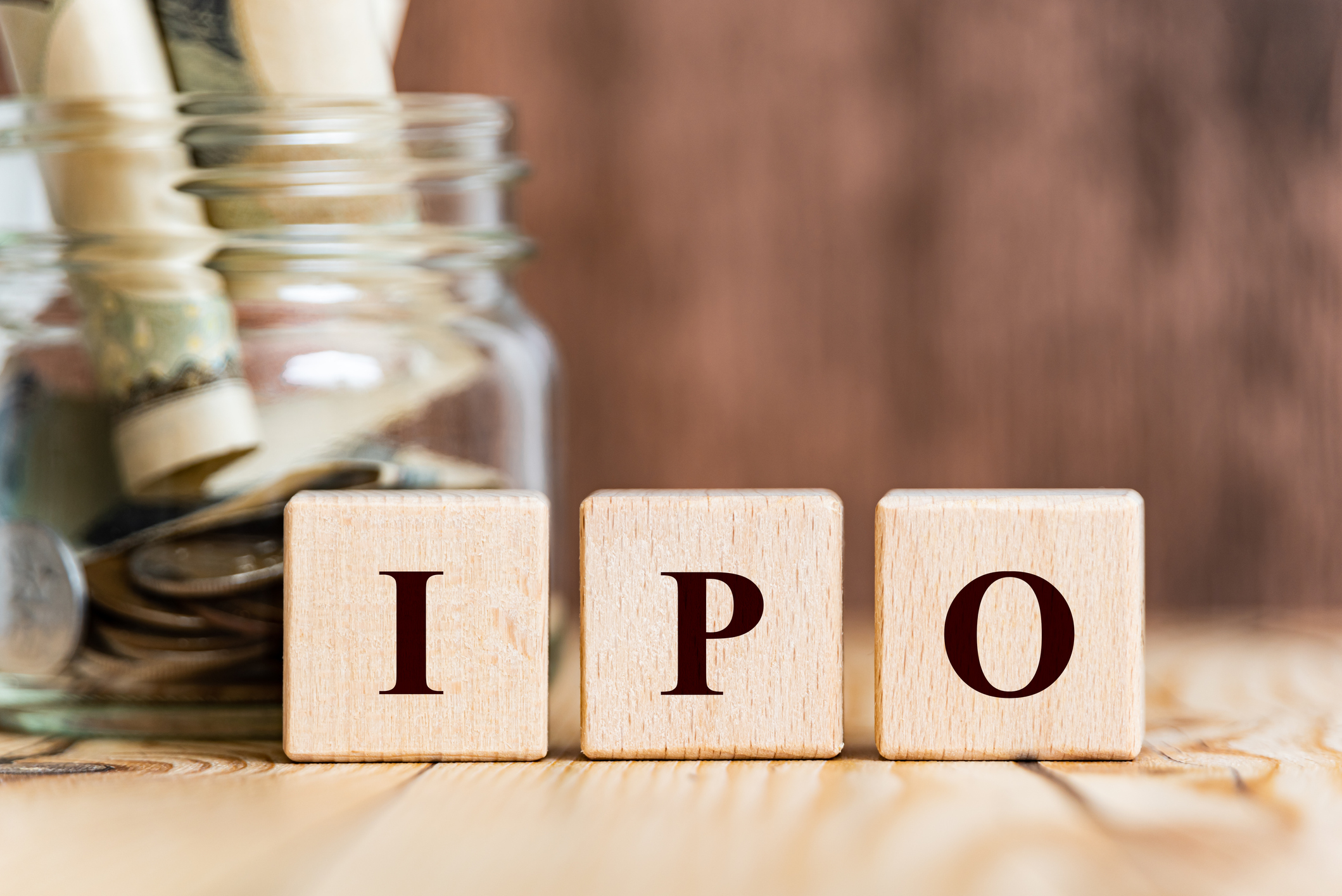 The letters "IPO" are in front of a jar with money.