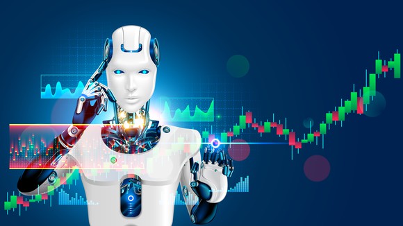 Standing behind a series of stock charts, a robot touches a finger to its head.