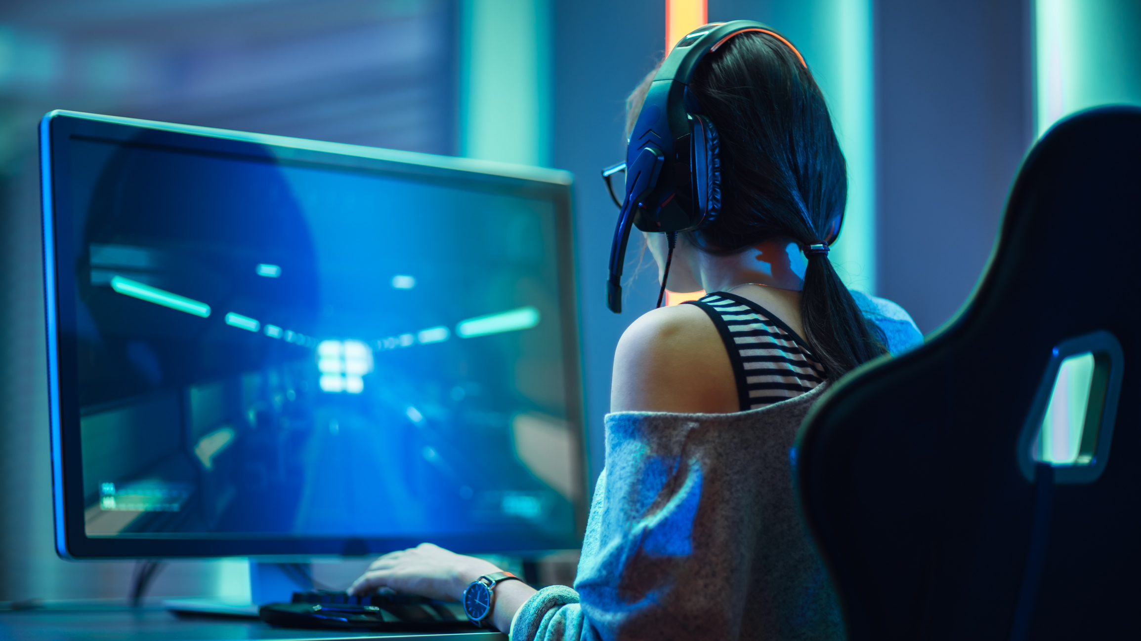 A girl playing a video game on a PC.
