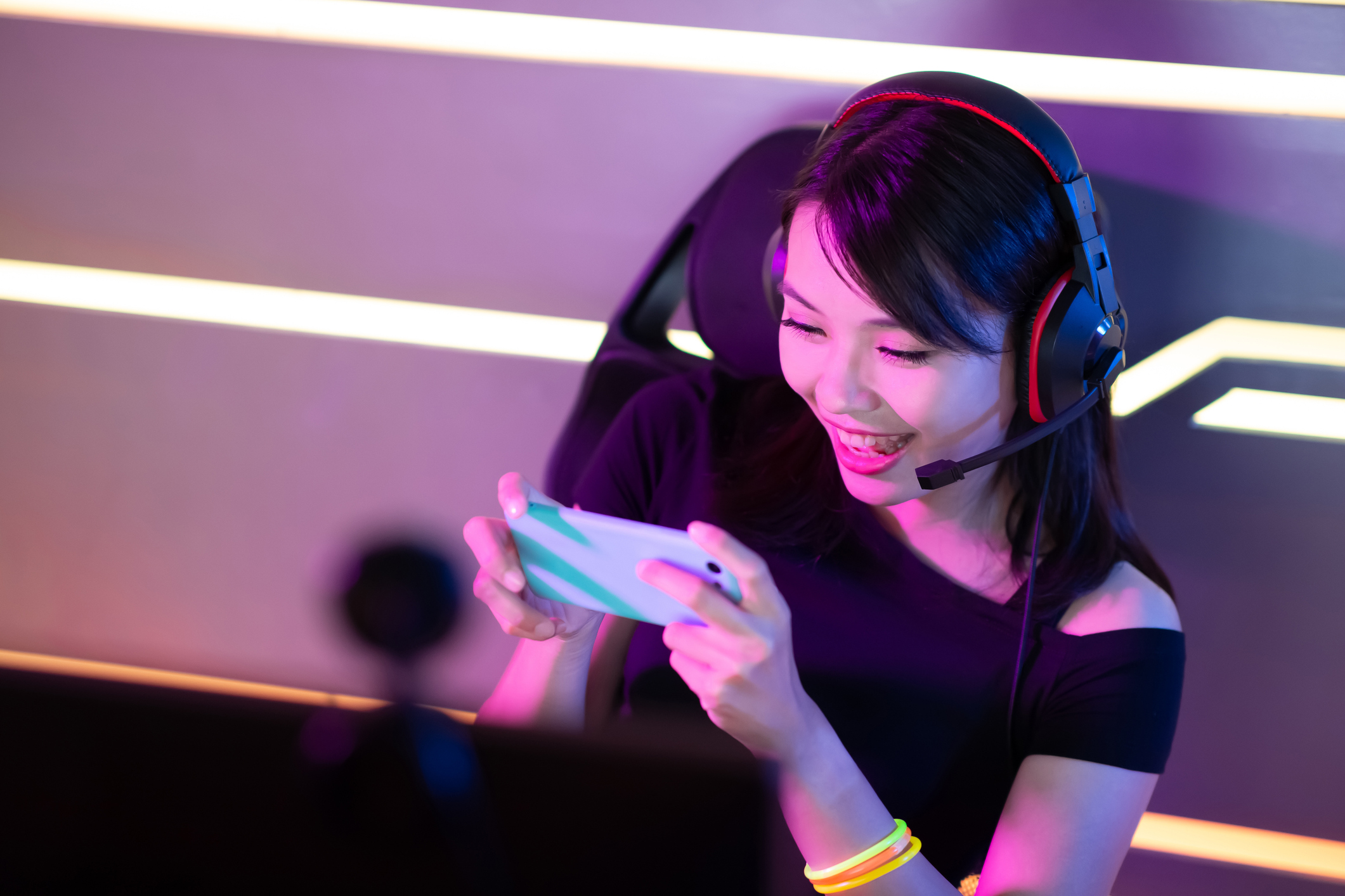 A young woman plays a mobile game.