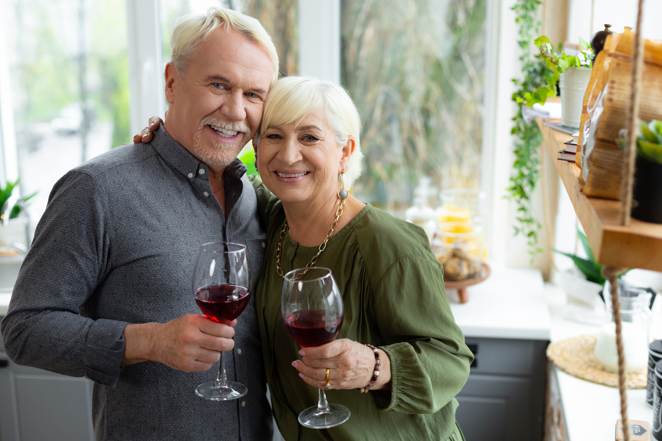 Older man and woman holding wine glasses