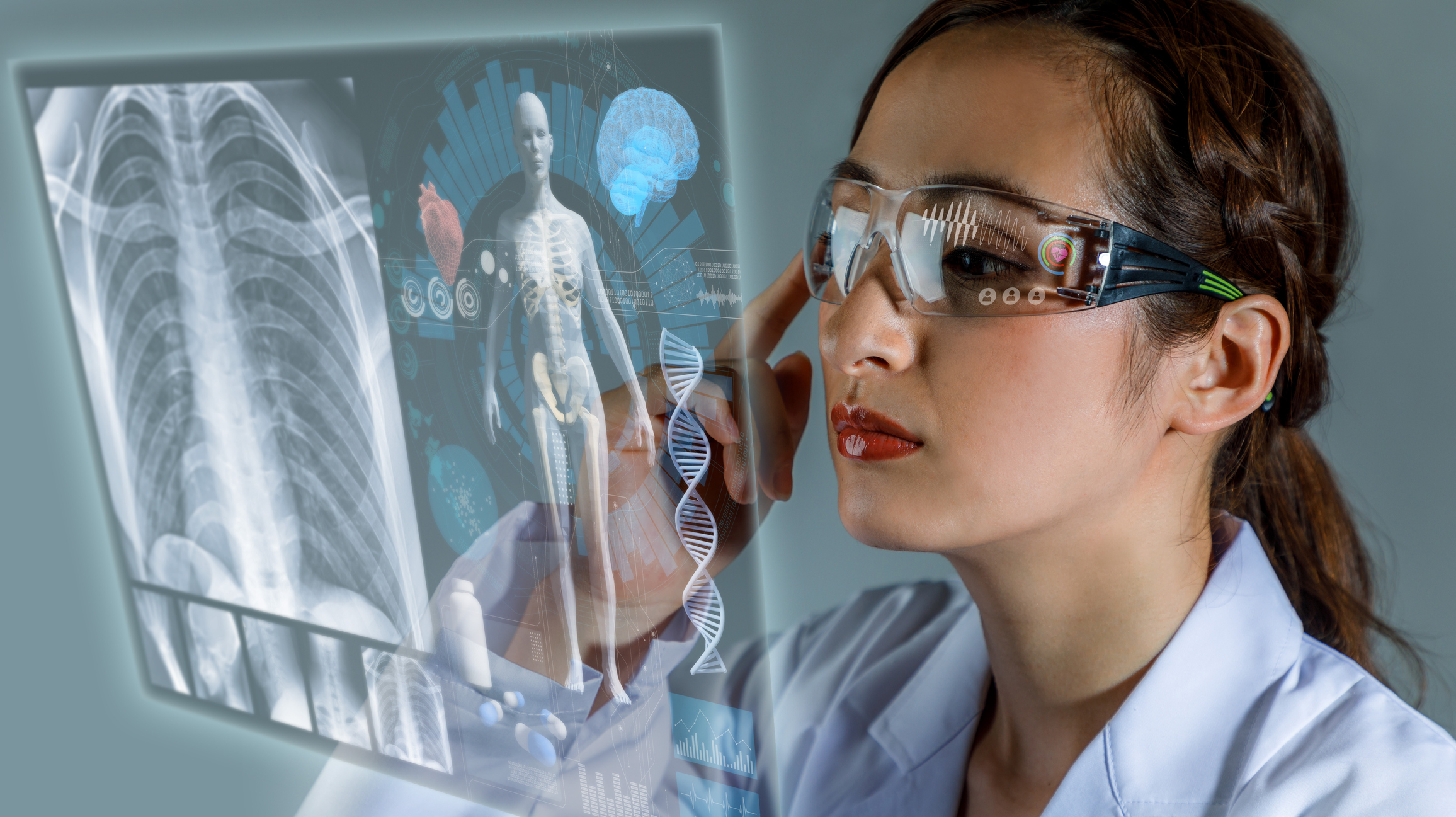 A doctor wearing smart glasses checks a patient's digital record.
