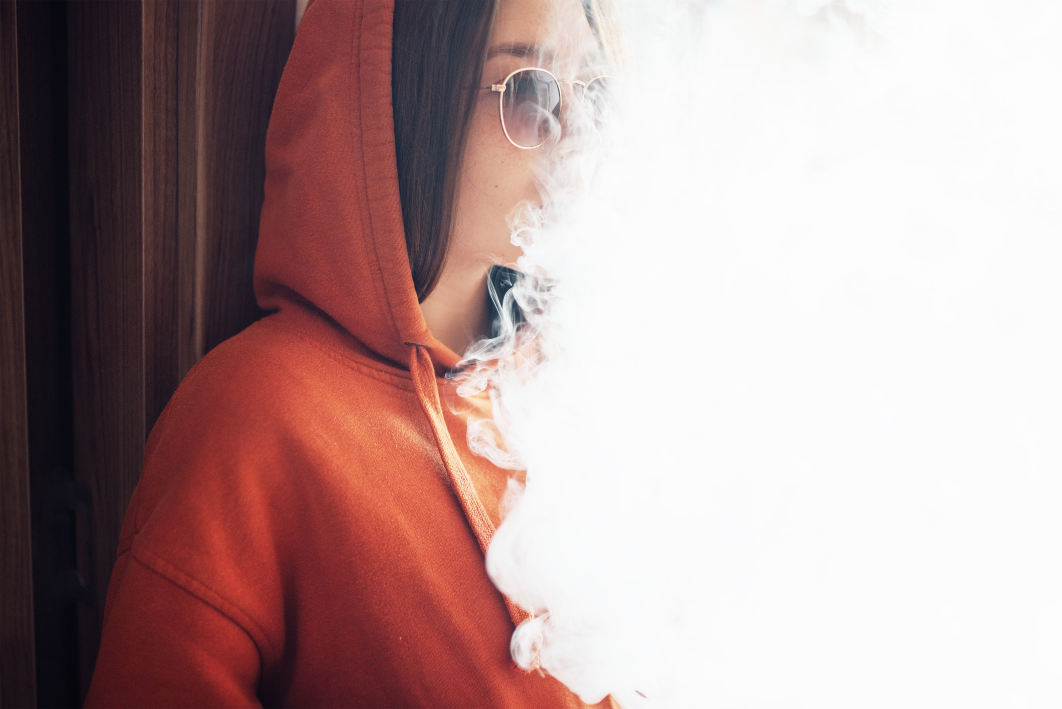 Woman releasing a large vapor cloud