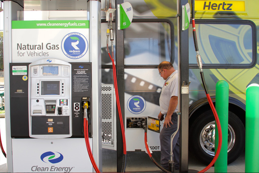 Man fueling bus with Clean Energy Fuels renewable natural gas.