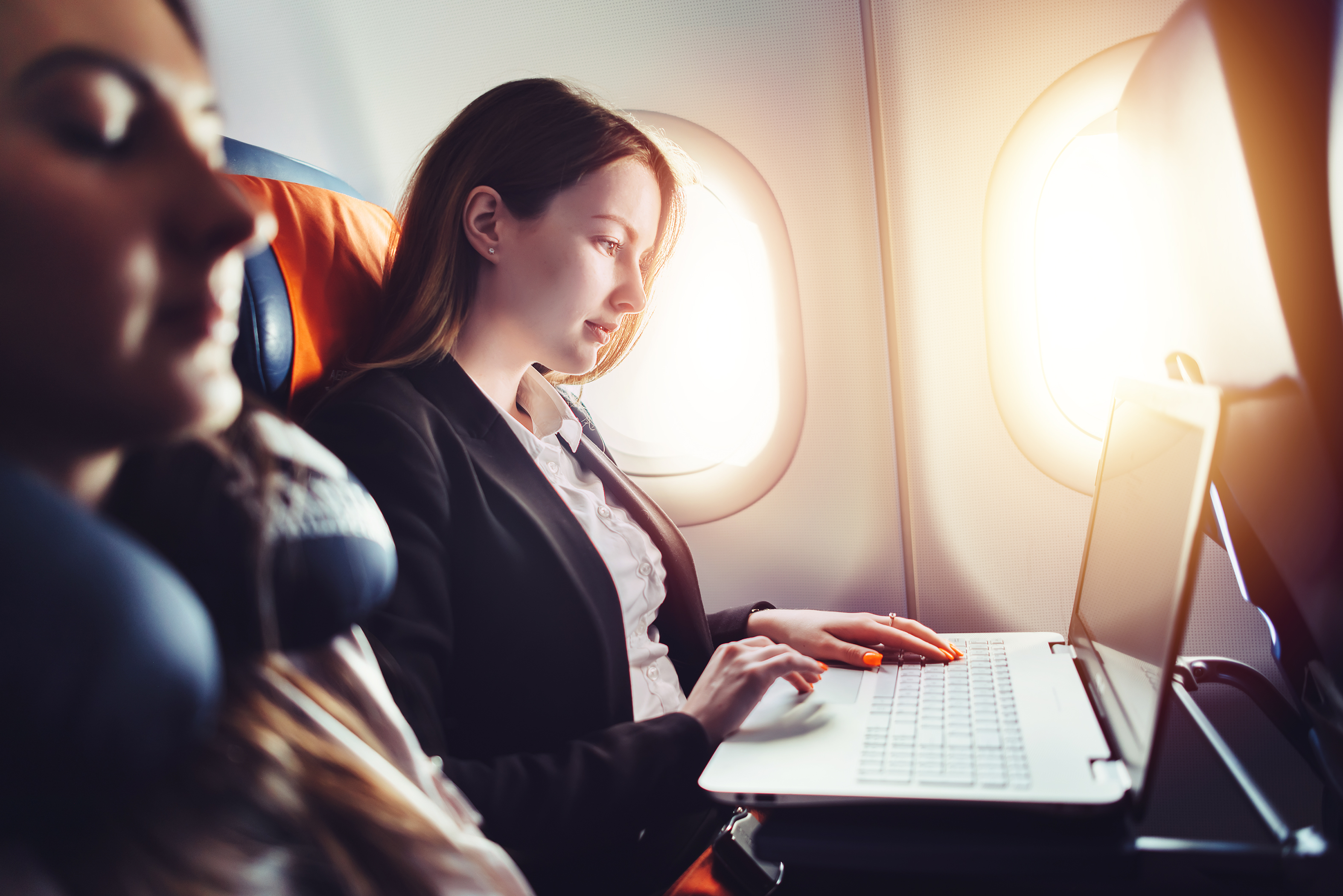 woman using laptop on plane
