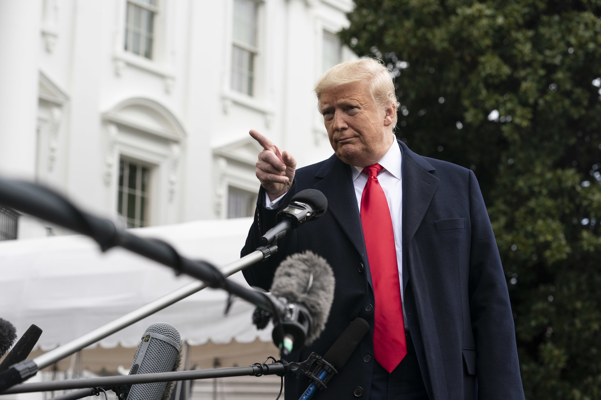 President Trump speaking with reporters on the White House lawn.