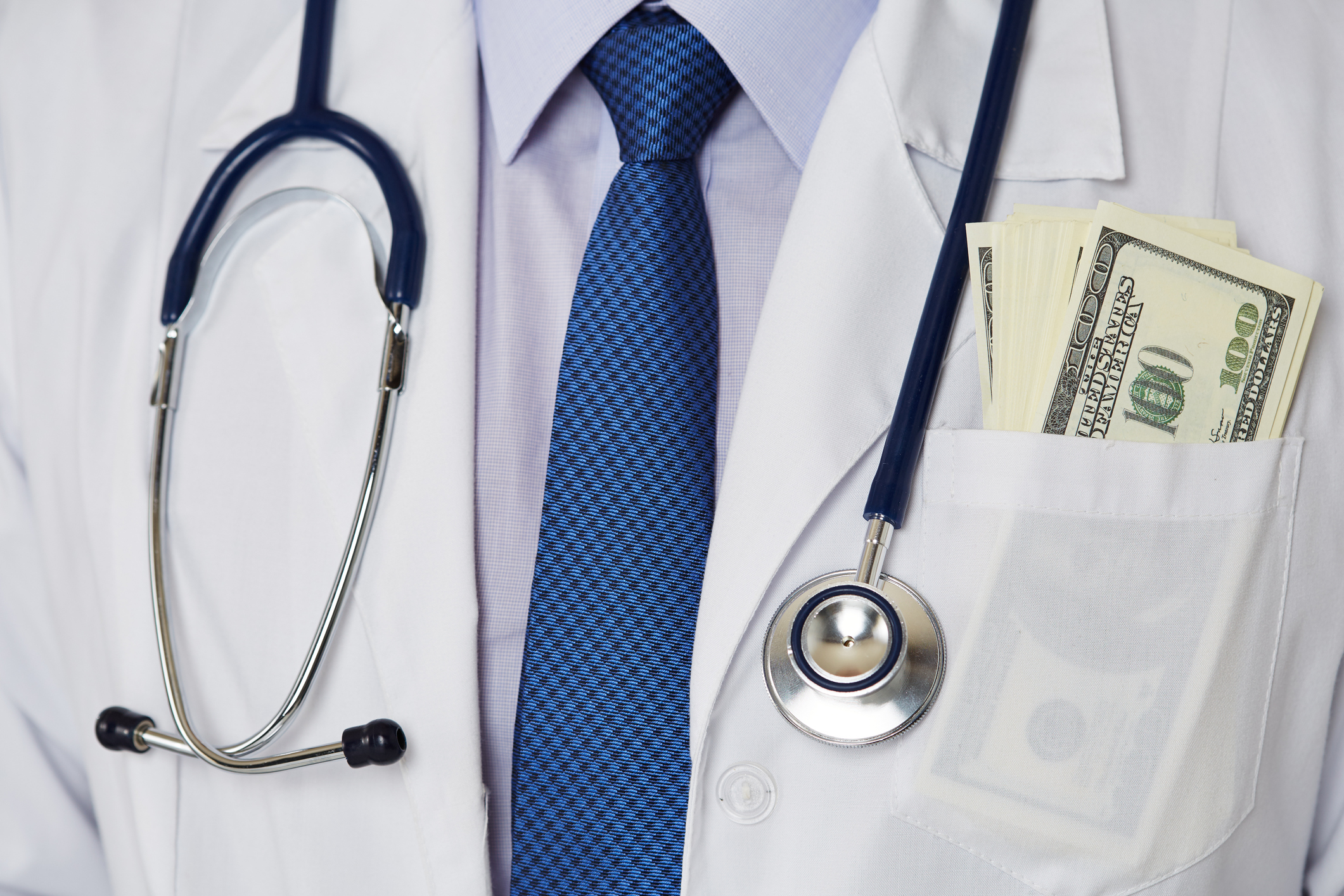 Doctor with cash in the breast pocket of their lab coat.