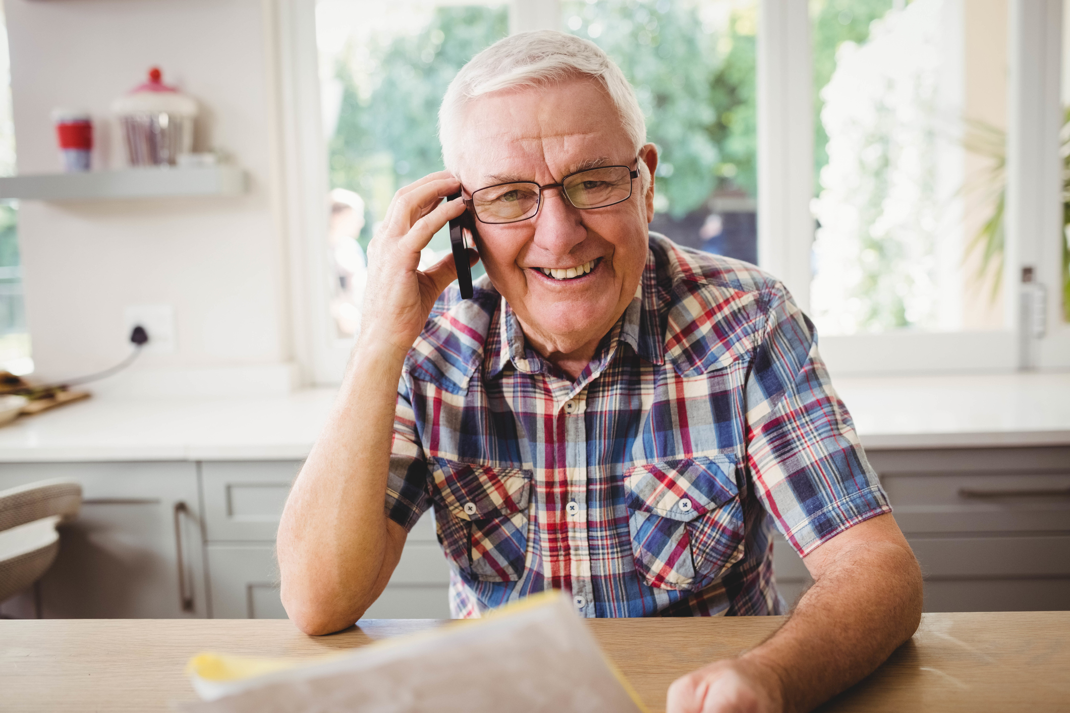 Smiling older man holding phone to ear