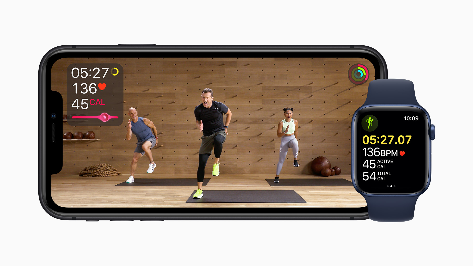 Apple Watch and iPhone displaying Apple Fitness+ interfaces