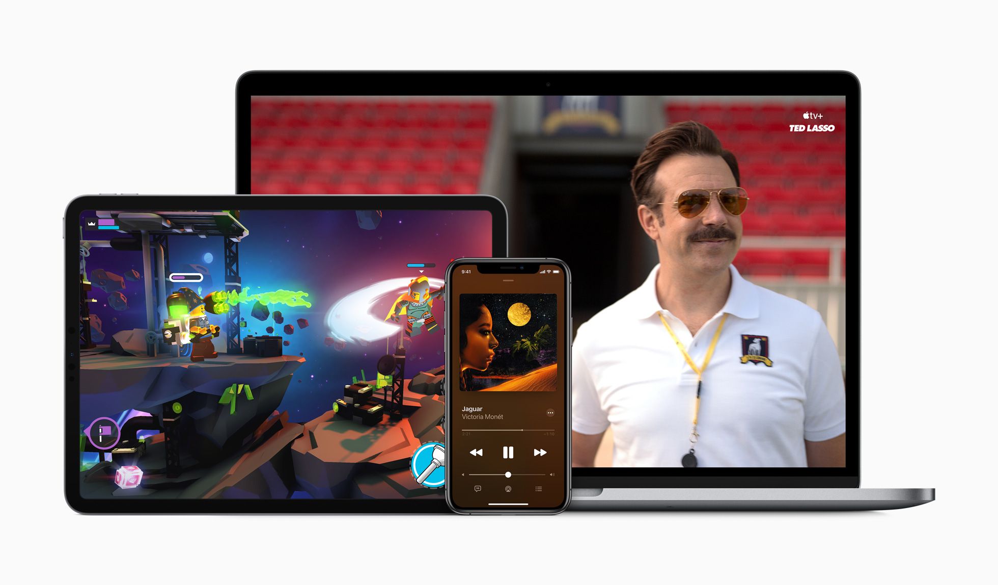 A MacBook displaying an Apple TV+ show, an iPhone displaying Apple Music, and an iPad displaying a game
