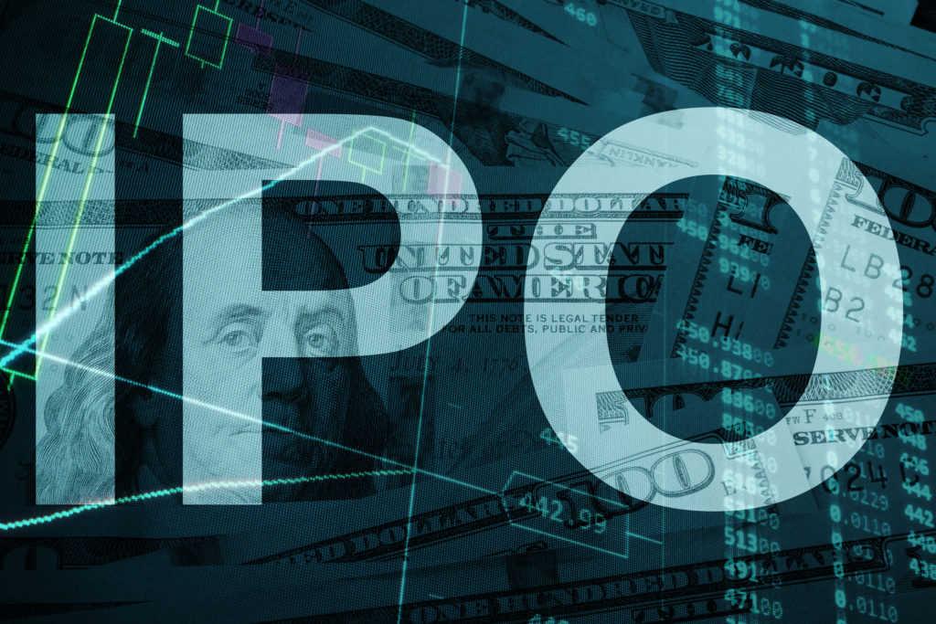 The letters IPO standing out over a dim background of hundred-dollar bills.
